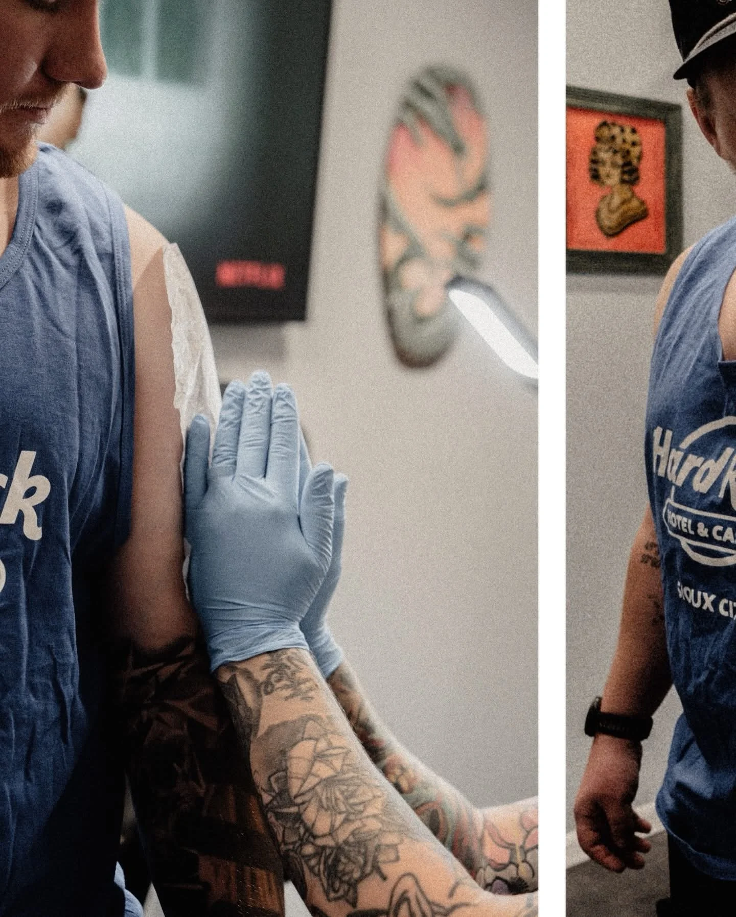 A person receiving a vaccination shot in their upper arm with a healthcare worker wearing gloves administering it; the person has arm tattoos, and another person stands nearby holding their hand.