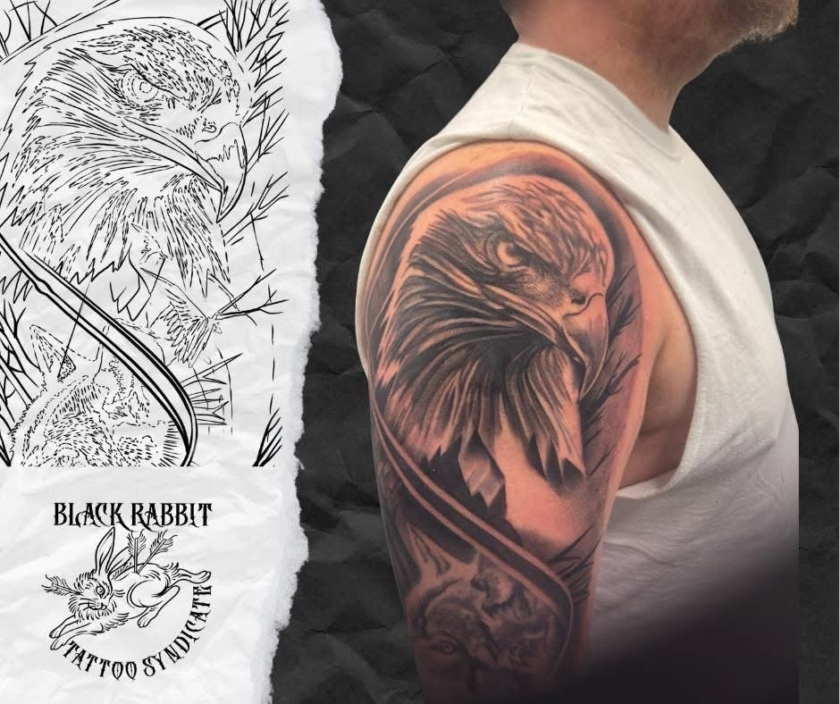 Tightly framed photo of a man's shoulder with a detailed black and gray tattoo of a lion's head. Next to the photo is a tattoo design sketch of an eagle and a rabbit with the text "Black Rabbit Tattoo Syndicate."