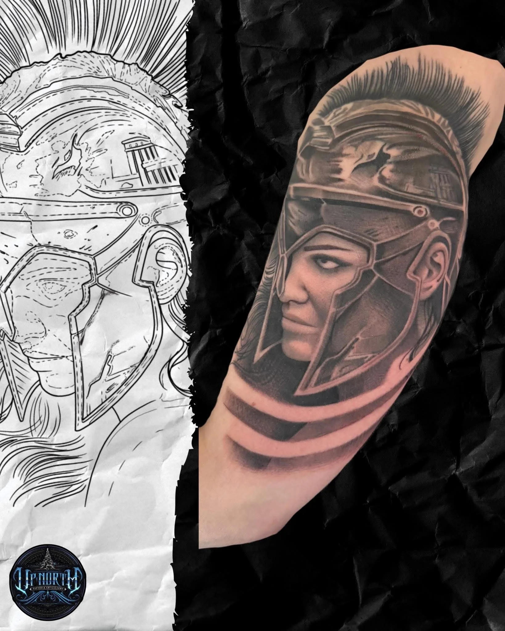 Close-up of a person's upper arm showing a detailed tattoo of a futuristic helmet featuring eyes and geometric patterns, with a background of crumpled black material and a black and white poster showing the helmet design.