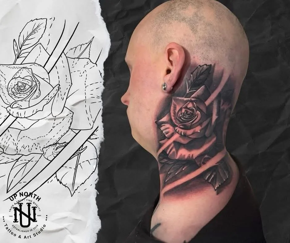 Close-up of a shaved head with a detailed black and gray rose tattoo behind the ear, next to a sketch of a similar rose tattoo design.