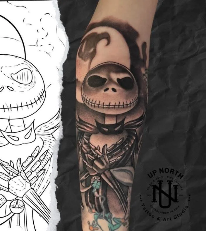 Tattoo of Jack Skellington from 'The Nightmare Before Christmas' on a person's forearm.