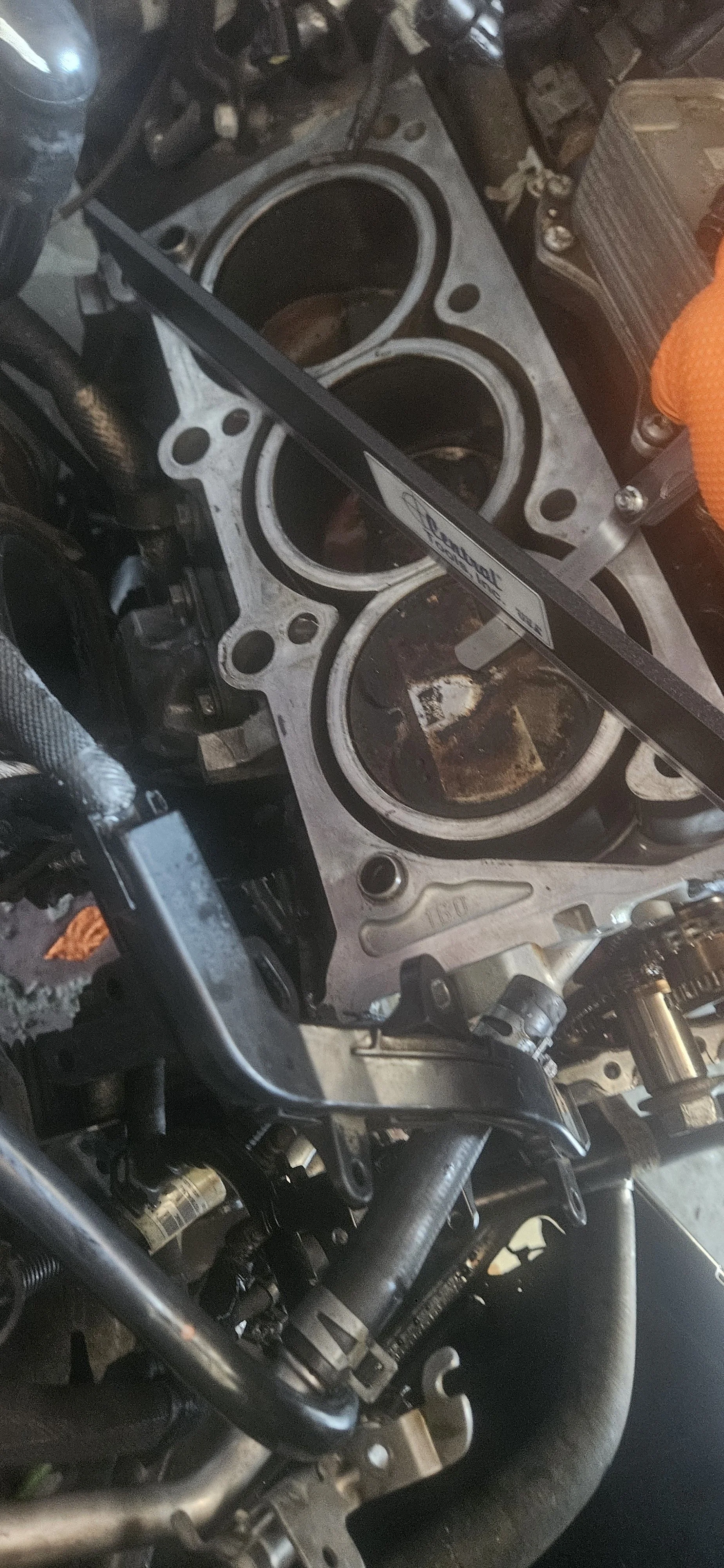 Open engine block of a vehicle with exposed cylinders, indicating engine repair or maintenance work.