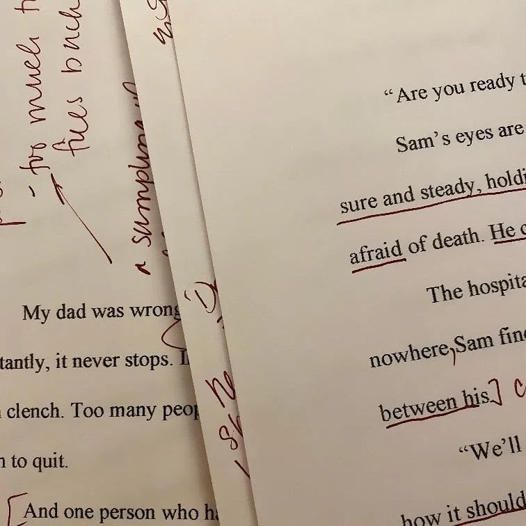 Lines of printed text with annotations in red ink and handwritten notes in red ink.