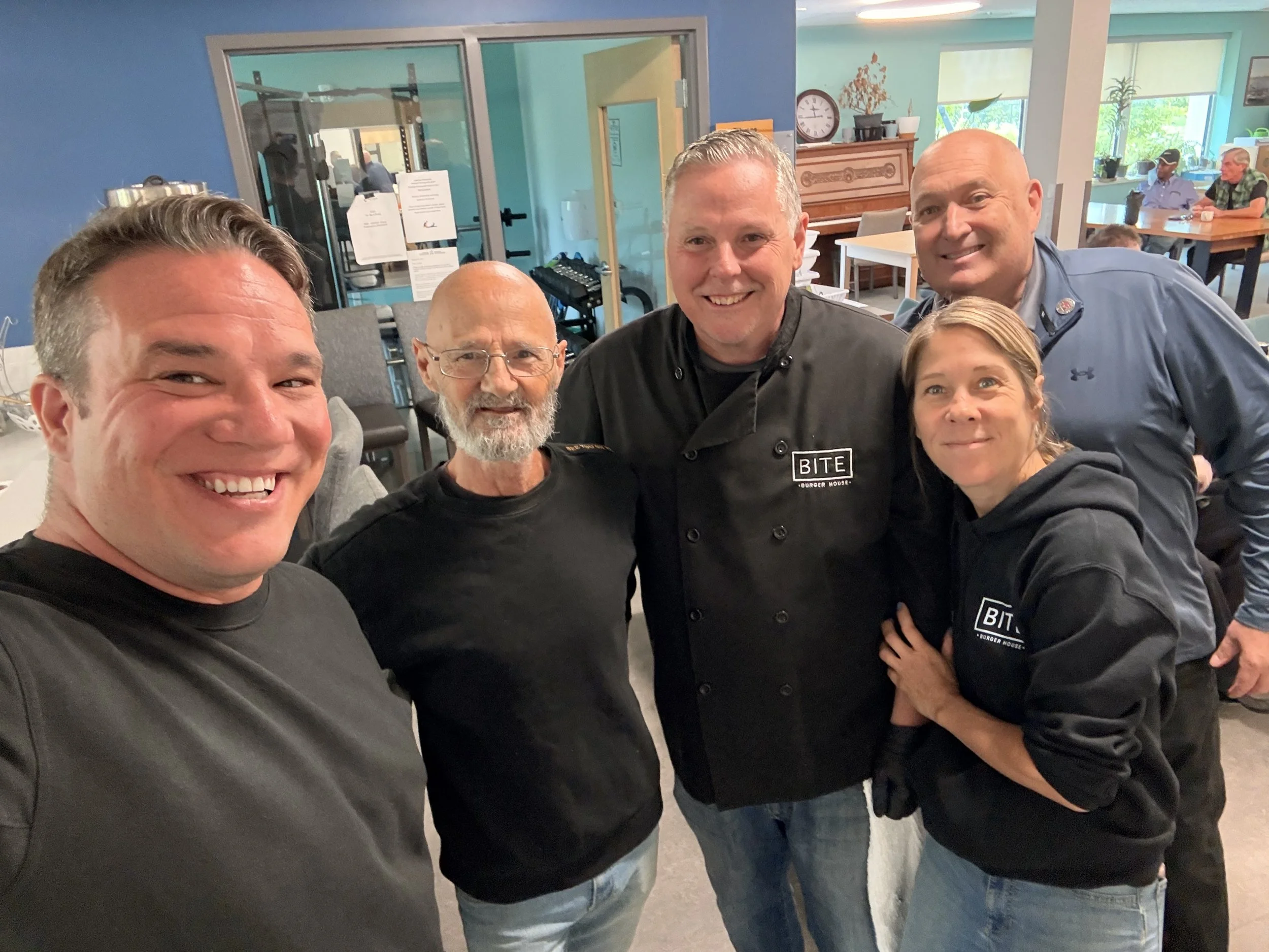Matt Luloff with veterans from Veterans House Canada and the owners of Bite Burger House.
