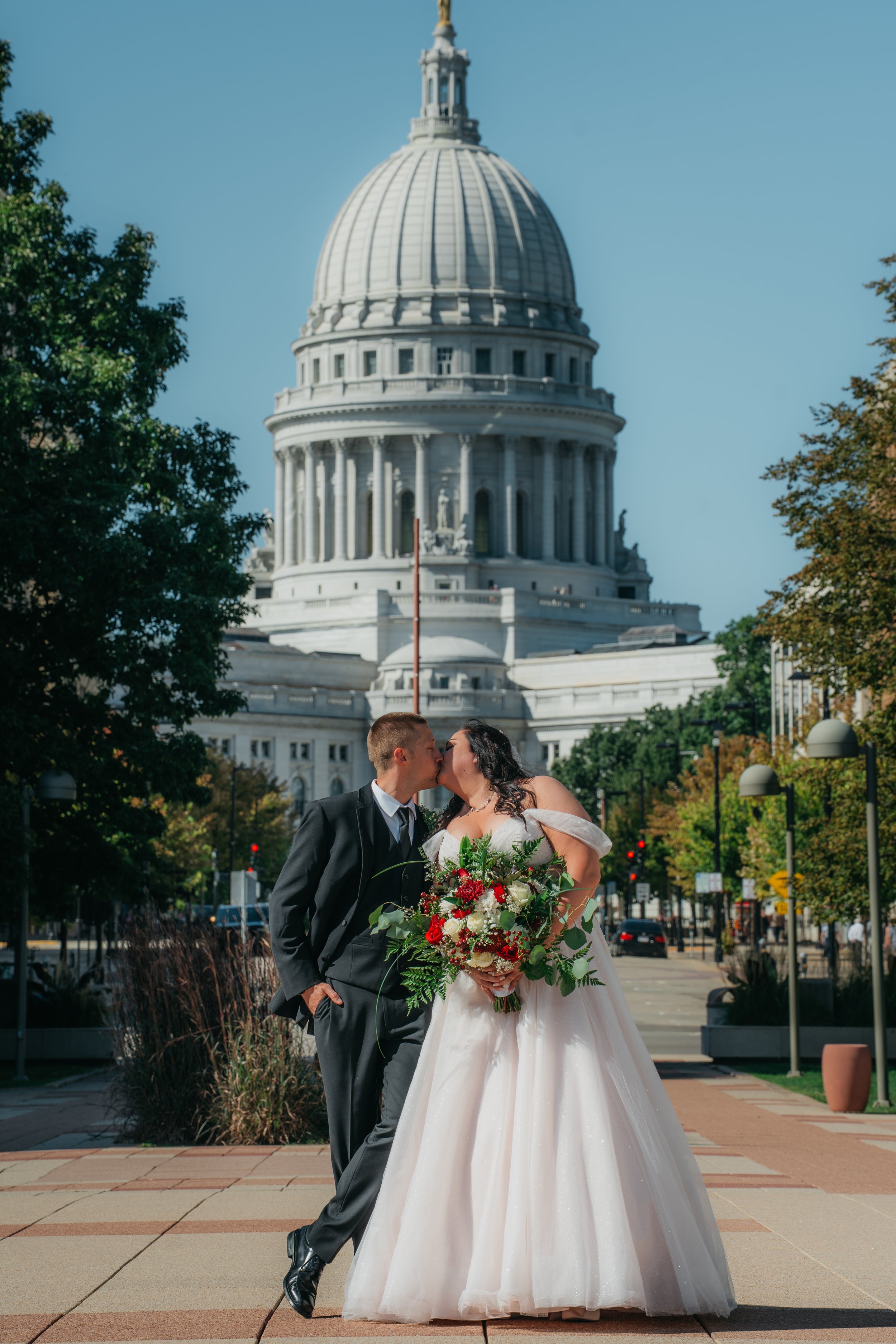 A candid bride and groom moment capturing real laughter, movement, and joy during the wedding day.