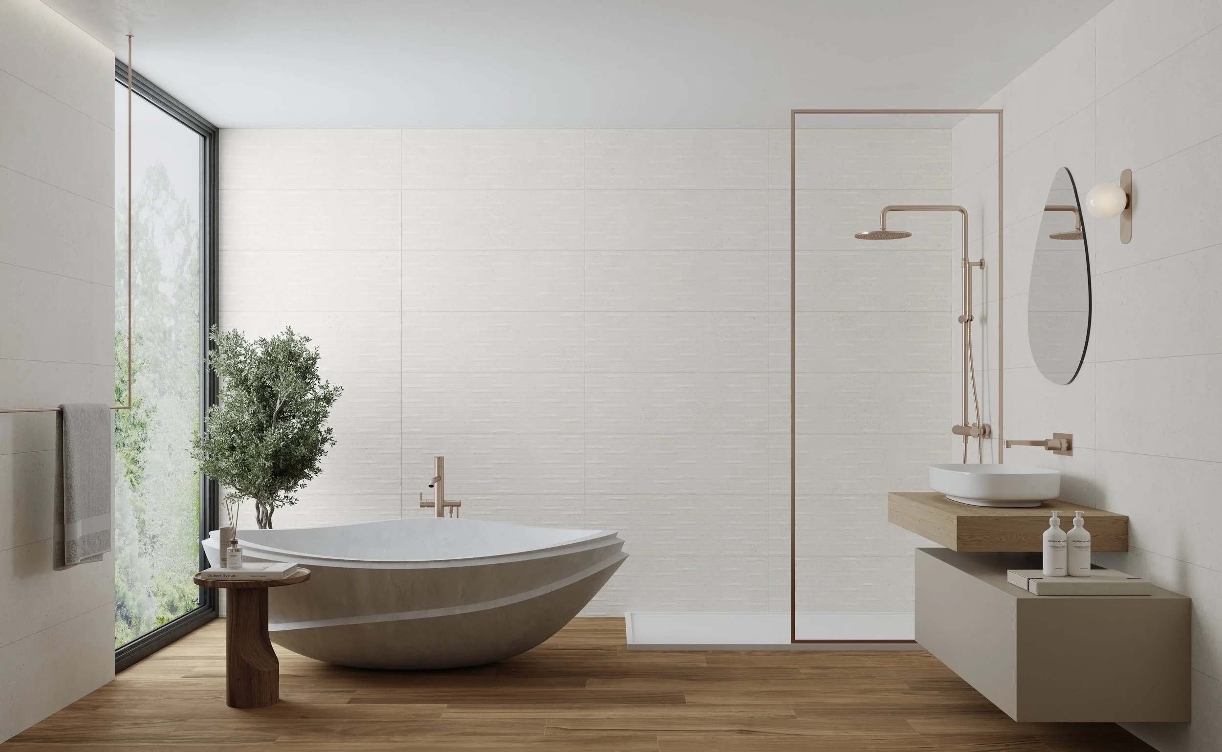 Salle de bain moderne avec une baignoire, un lavabo sur un meuble en bois, une grande fenêtre laissant entrer la lumière naturelle, une plante verte, un miroir rond et une douche séparée avec mur en verre.