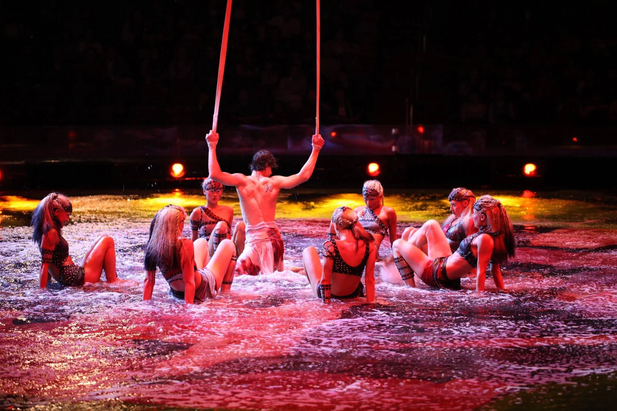 Dynamic dancers in straps section of world's largest water show, The House of Dancing Water. Franco Dragone.