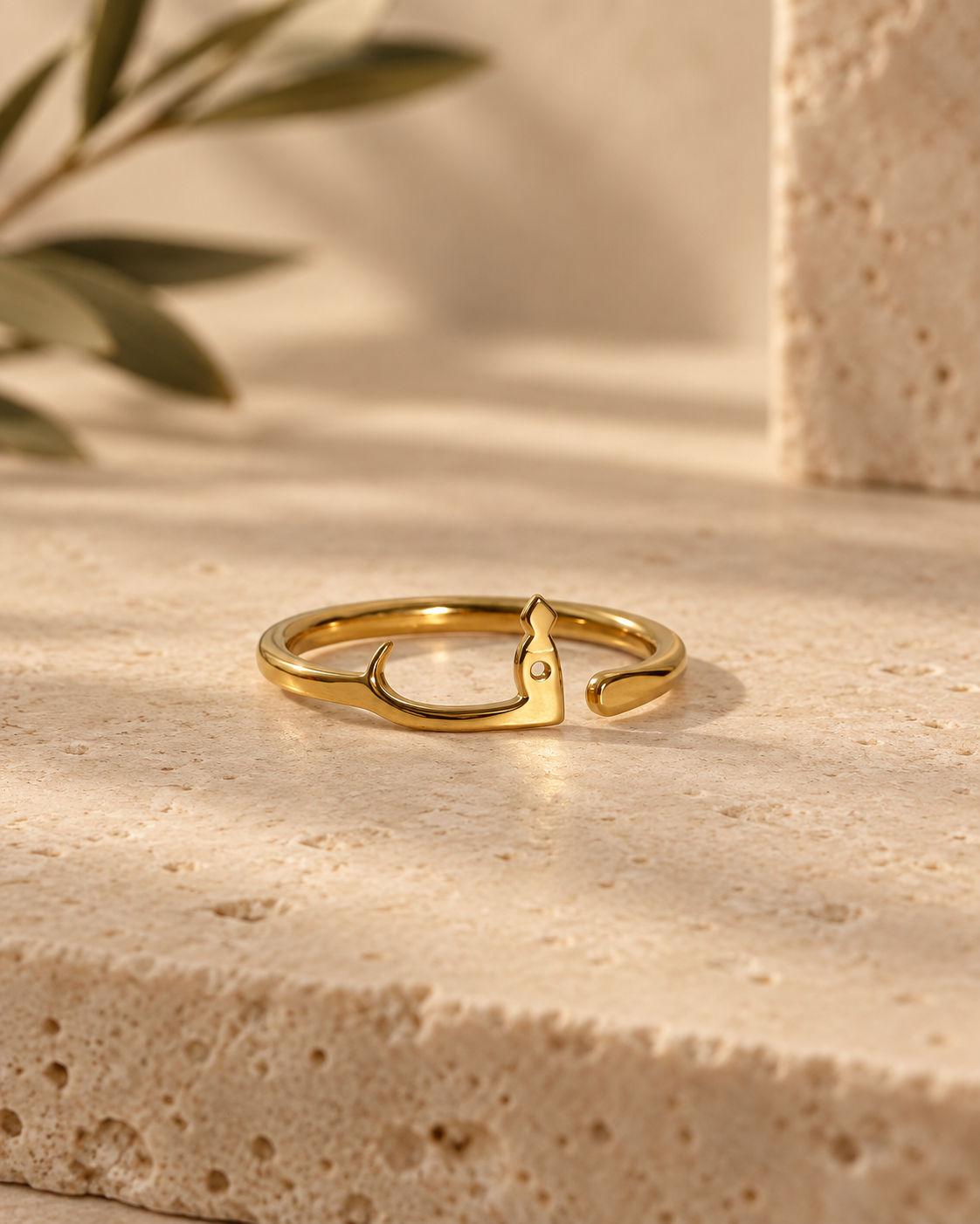 Golden Arabic Letter Ring on Travertine.png