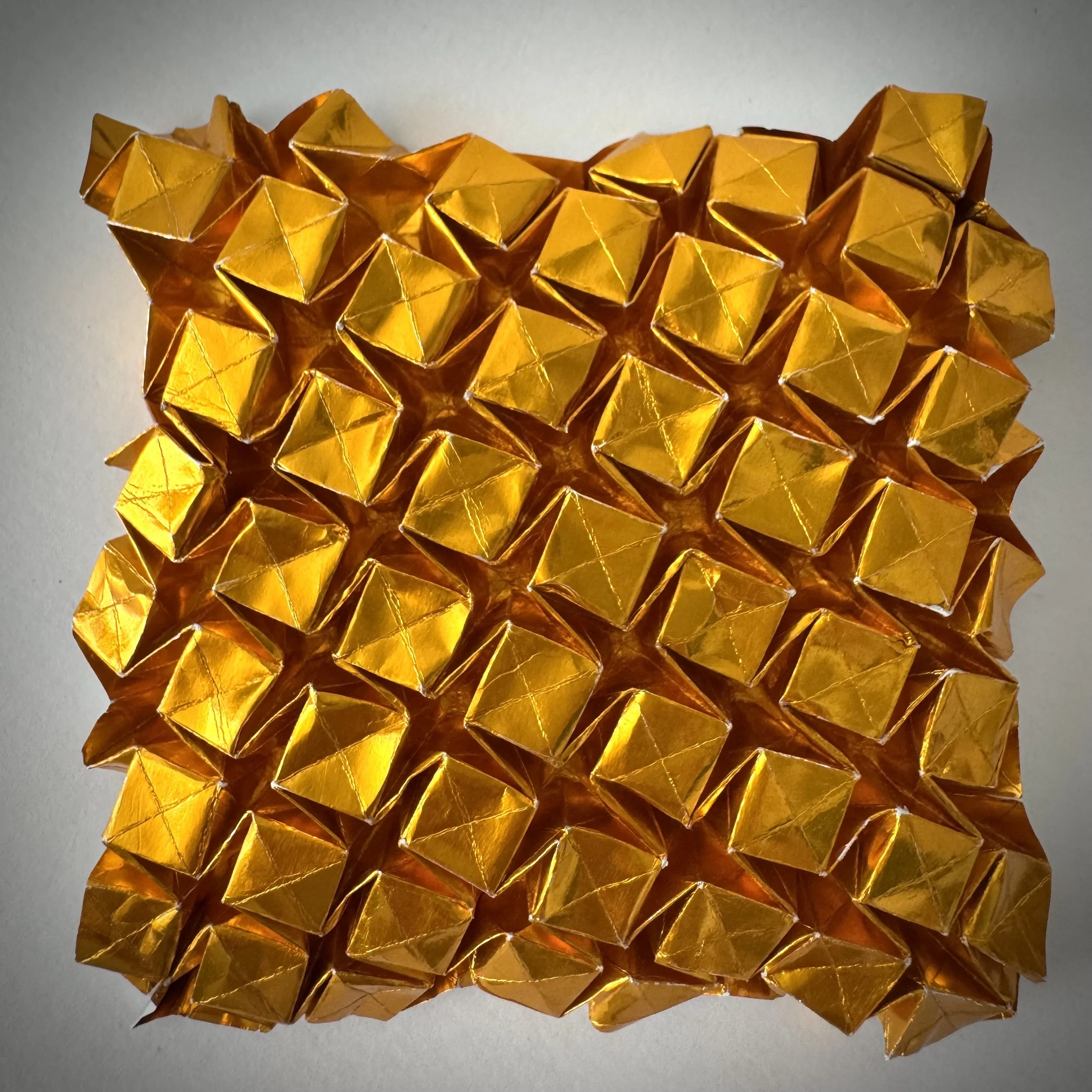 This fold is tedious. One moment of lost focus and it collapses. And it doesn’t compress — you can’t fold it away. But each small square shifts at a slight angle, and that movement must be useful for something. I just haven’t figured out what yet.
