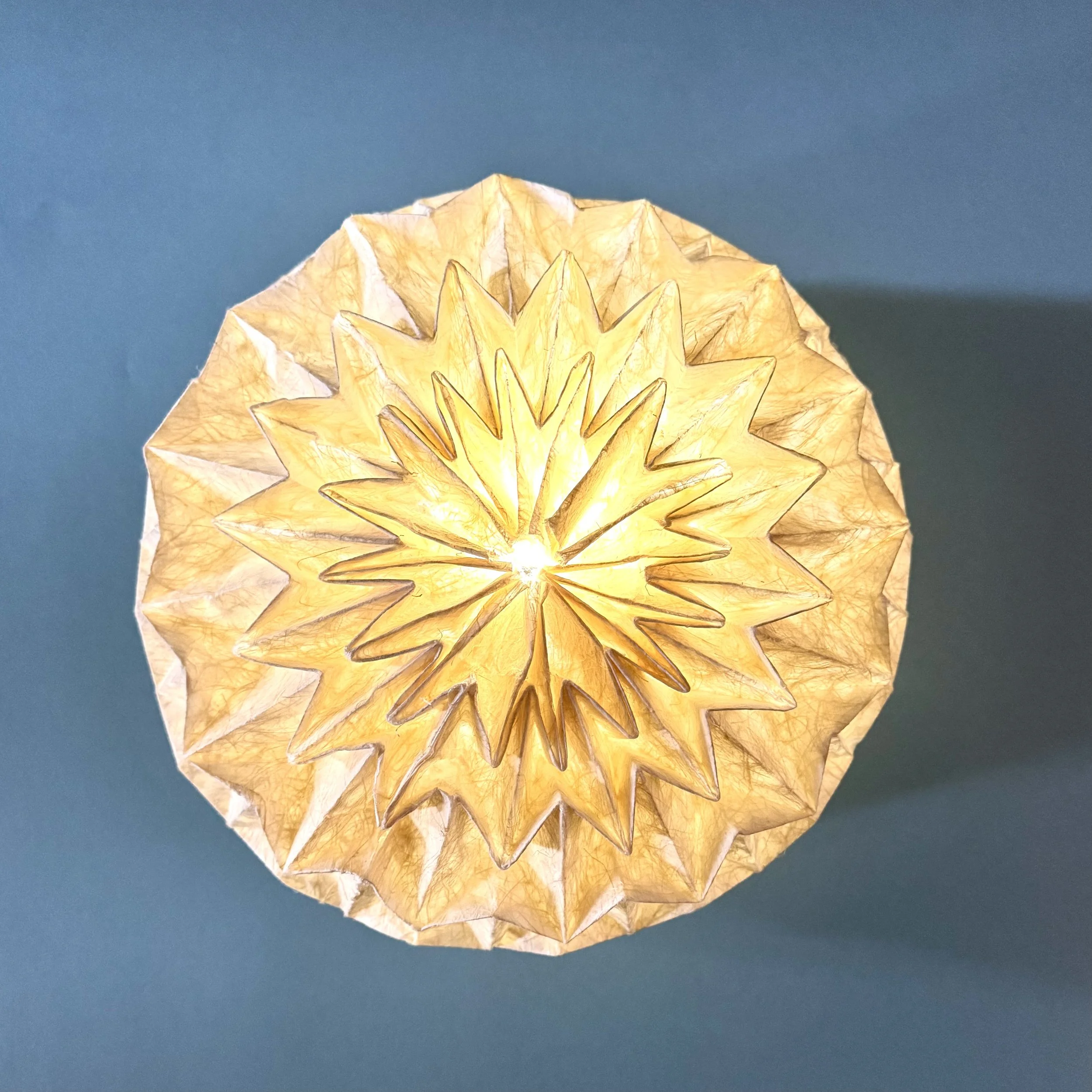 You cannot tear it by hand. Yet it glows, transforms into different shapes, collapses flat for travel, and feels like luxury. Origami is not just art — it is engineering.
