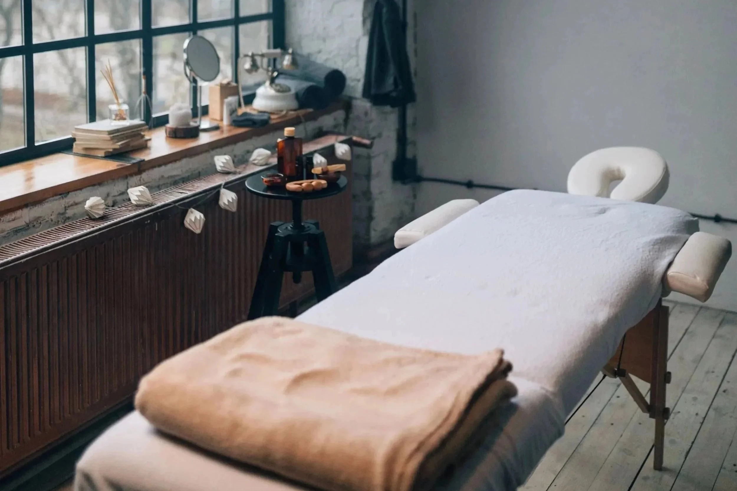 Beauty treatment room with a treatment bed and equipment.