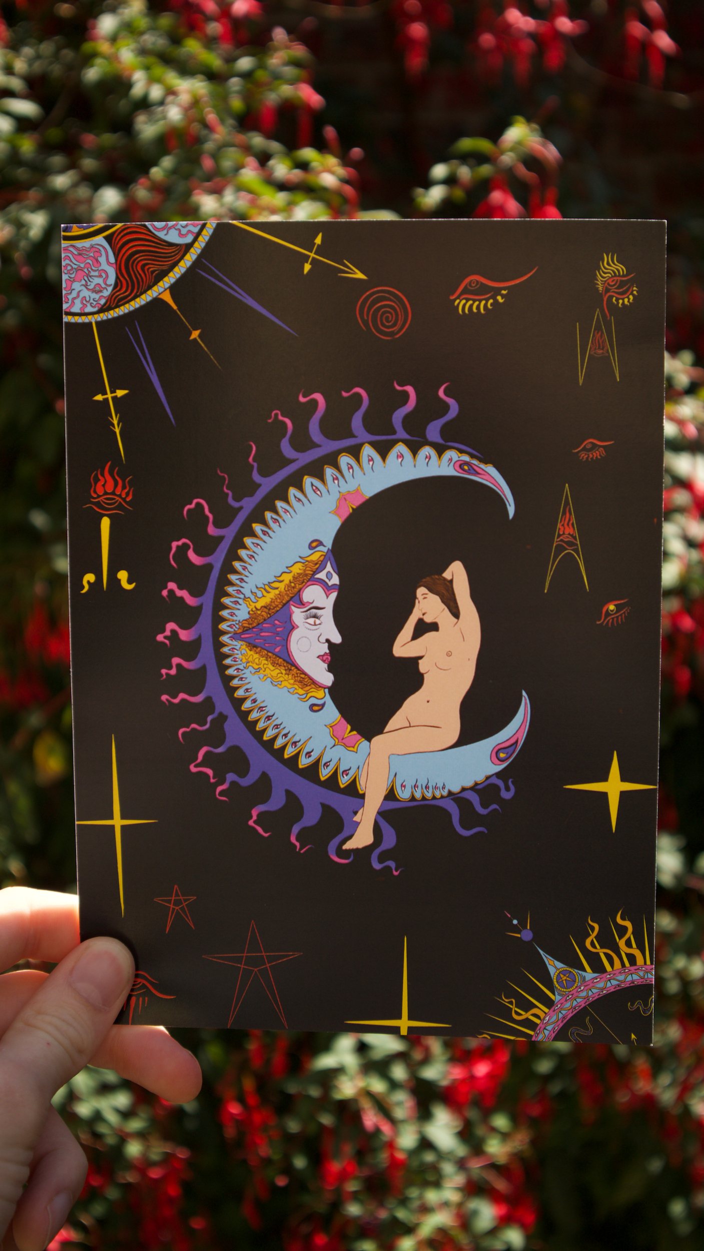 The Moon tarot art print held against a floral background - a psychedelic art nouveau interpretation of The Moon tarot card