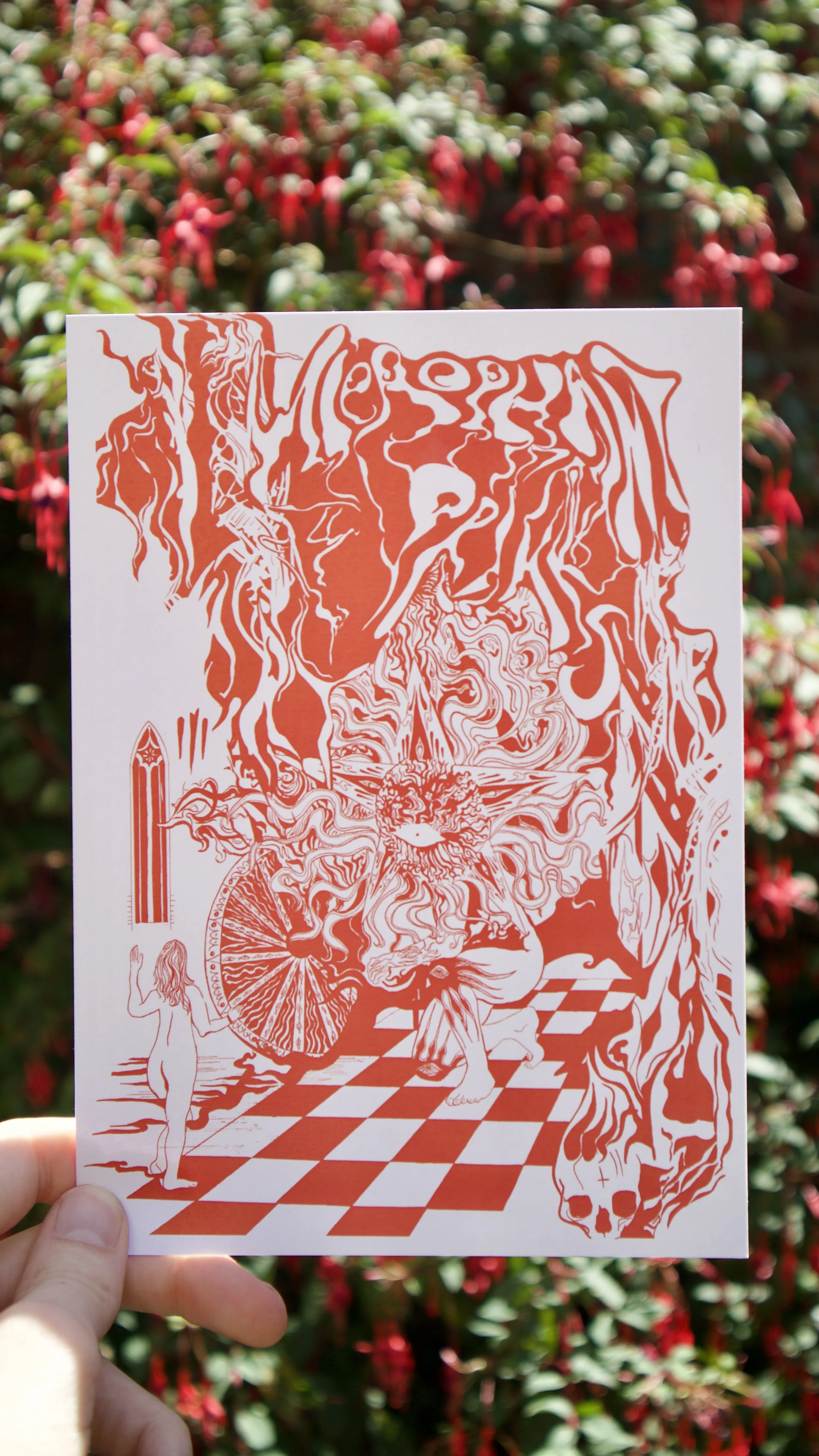 Hierophant Prints poster held against a floral background - a red and white ink print featuring psychedelic esoteric imagery.