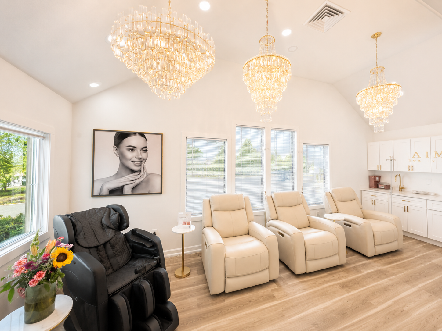 JENNVIE Med Spa IV therapy lounge in Westport, CT with luxury cream recliners and modern chandeliers