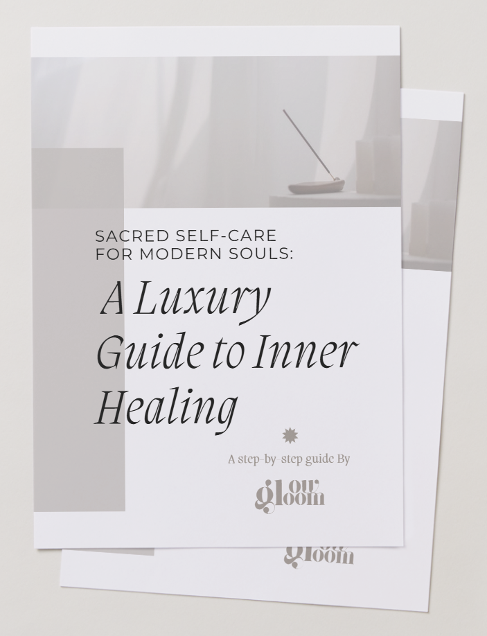 Brochure titled 'A Luxury Guide to Inner Healing' with subtitle 'Sacred Self-Care for Modern Souls' and logo 'our gloom' at the bottom, placed on a light-colored surface.