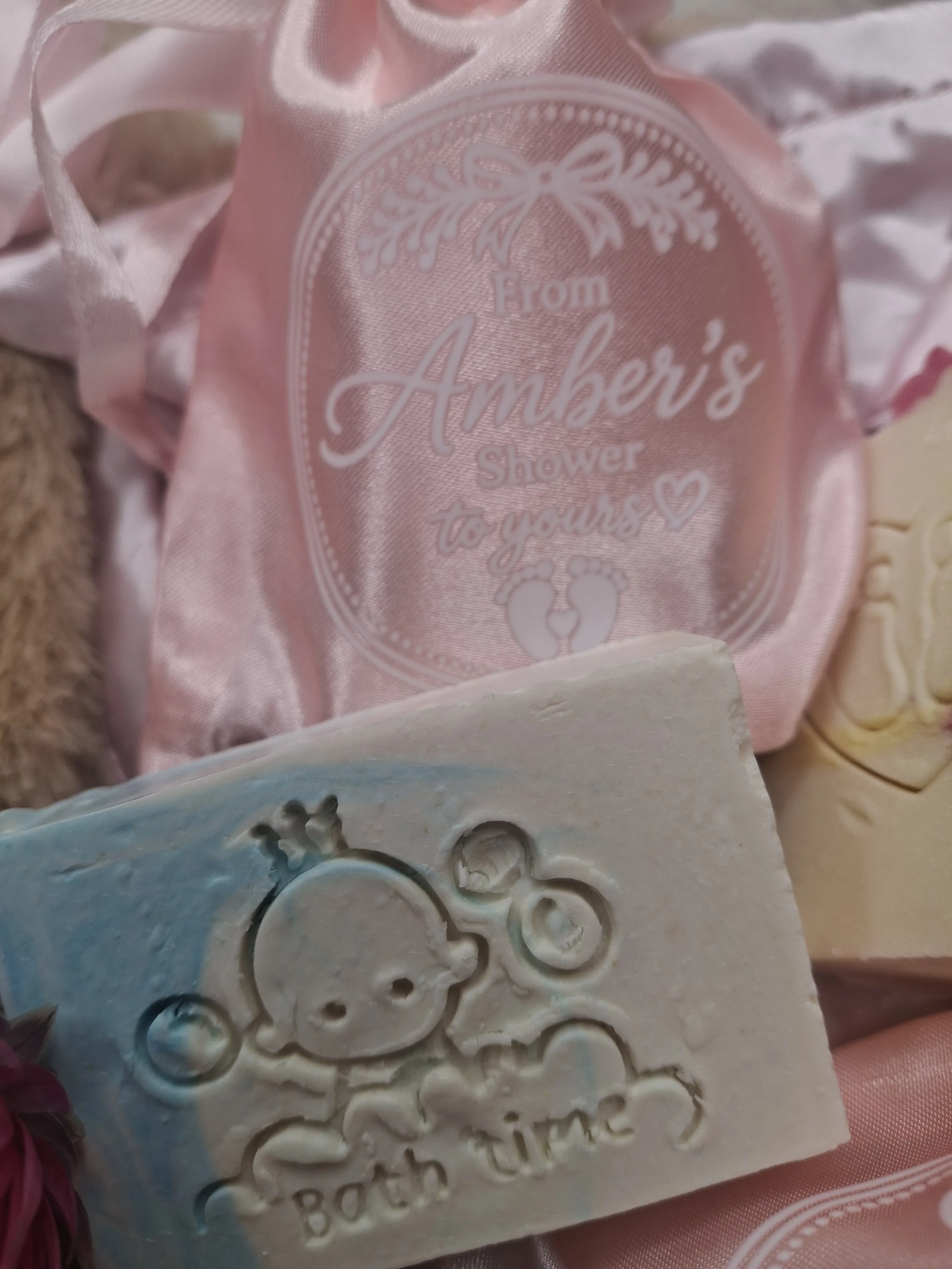 Blue and white Bath Time baby shower soap favour displayed with a personalised satin gift bag
