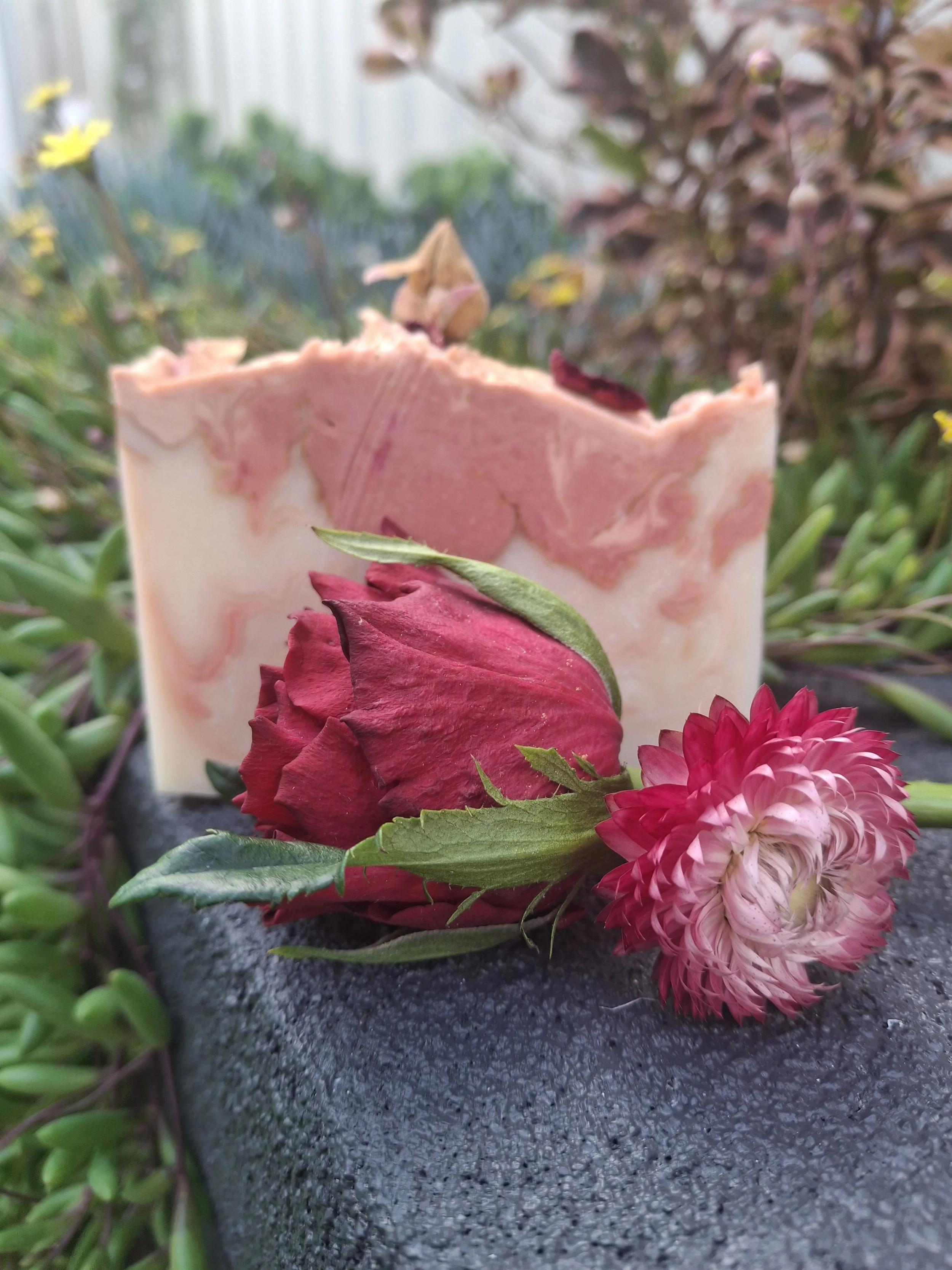 Close-up of Velvet Bloom artisan tallow soap with coconut cream, kaolin clay and a luxurious rose fragrance.