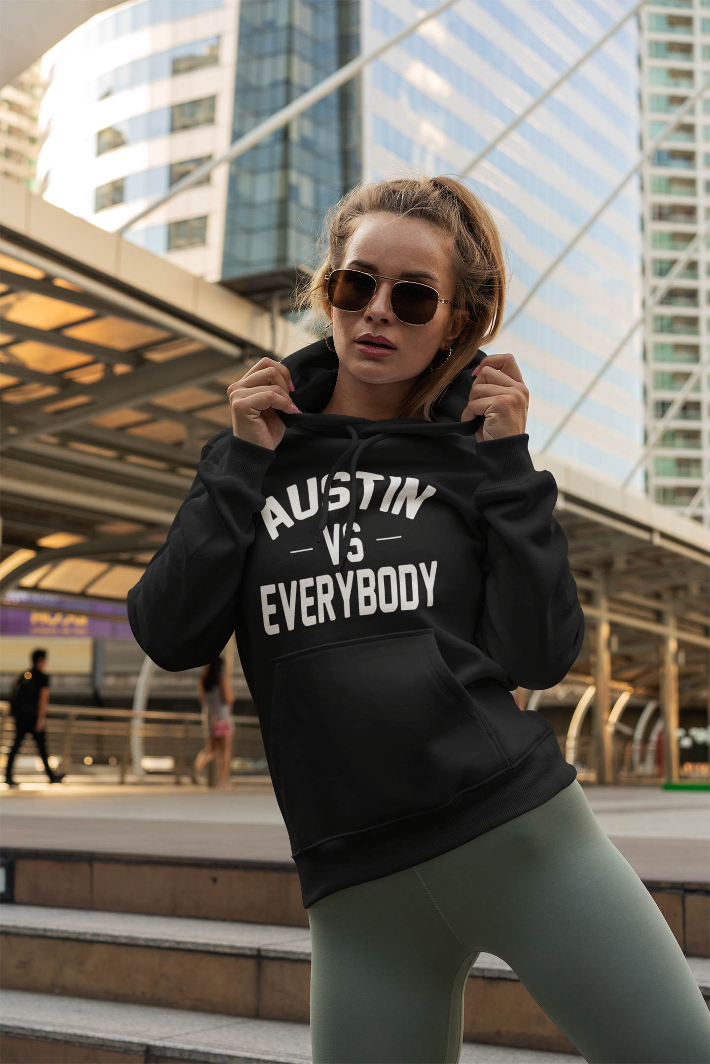 mockup-of-a-trendy-woman-posing-with-a-hoodie-next-to-a-bridge-3557-el1.png