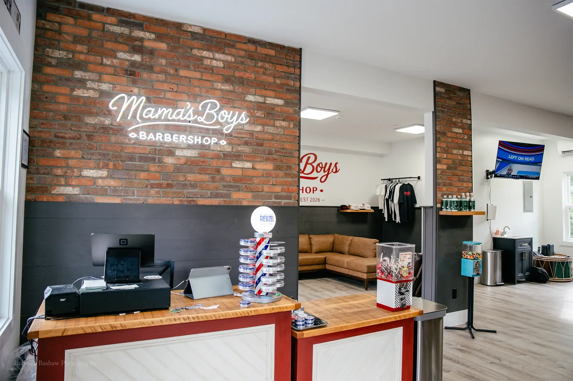 Modern interior of Mama’s Boys Barbershop reception and waiting area.