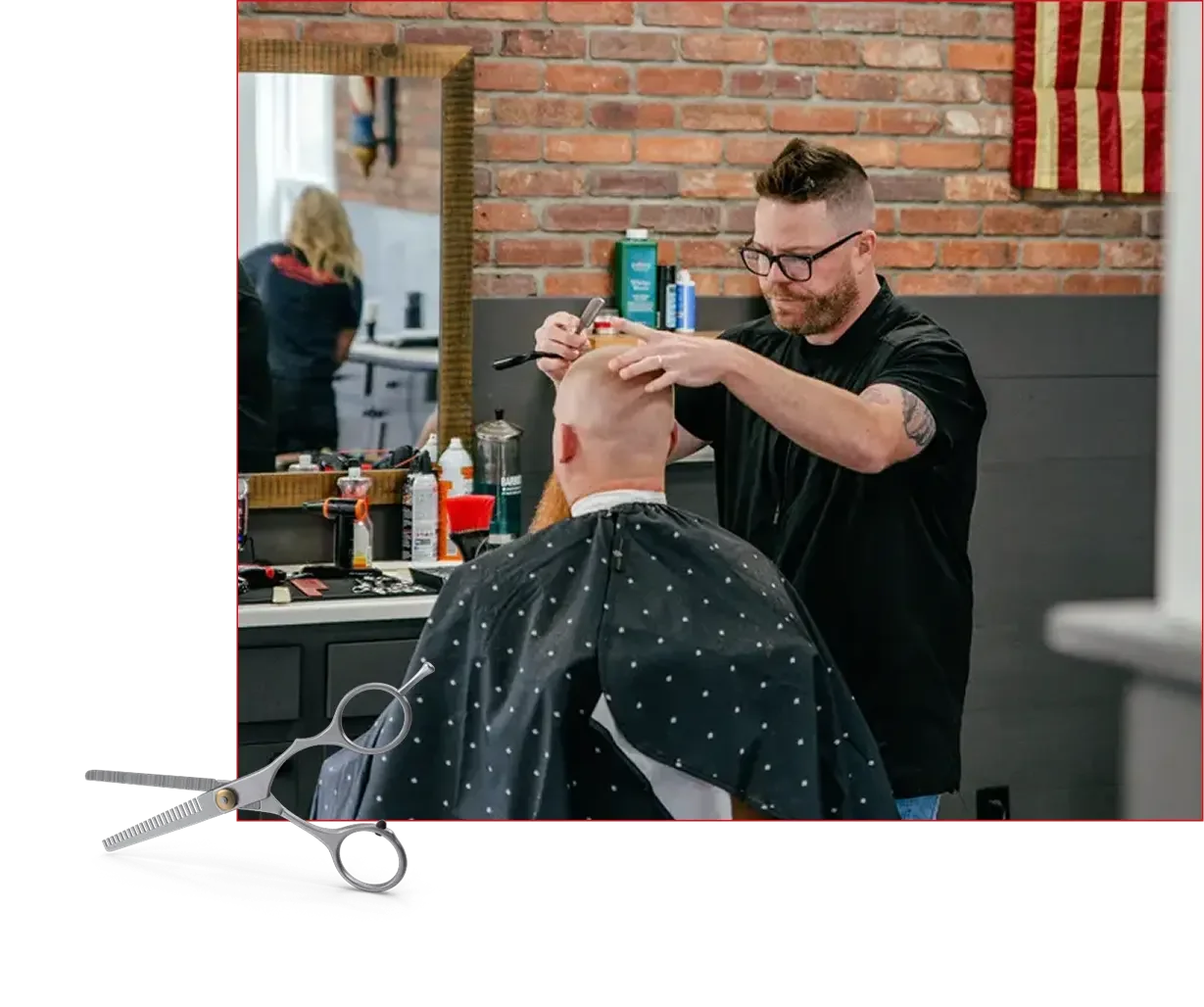 Experienced barber providing a men's haircut at Mama's Boys Barbershop.