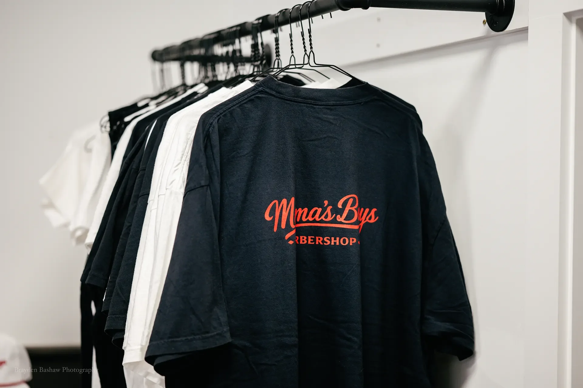 Mama's Boys Barbershop branded T-shirts available for purchase in the shop.