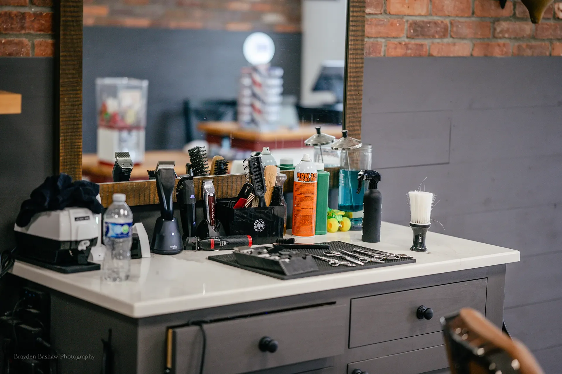 Professional barber workstation with grooming tools and styling products at Mama's Boys Barbershop.