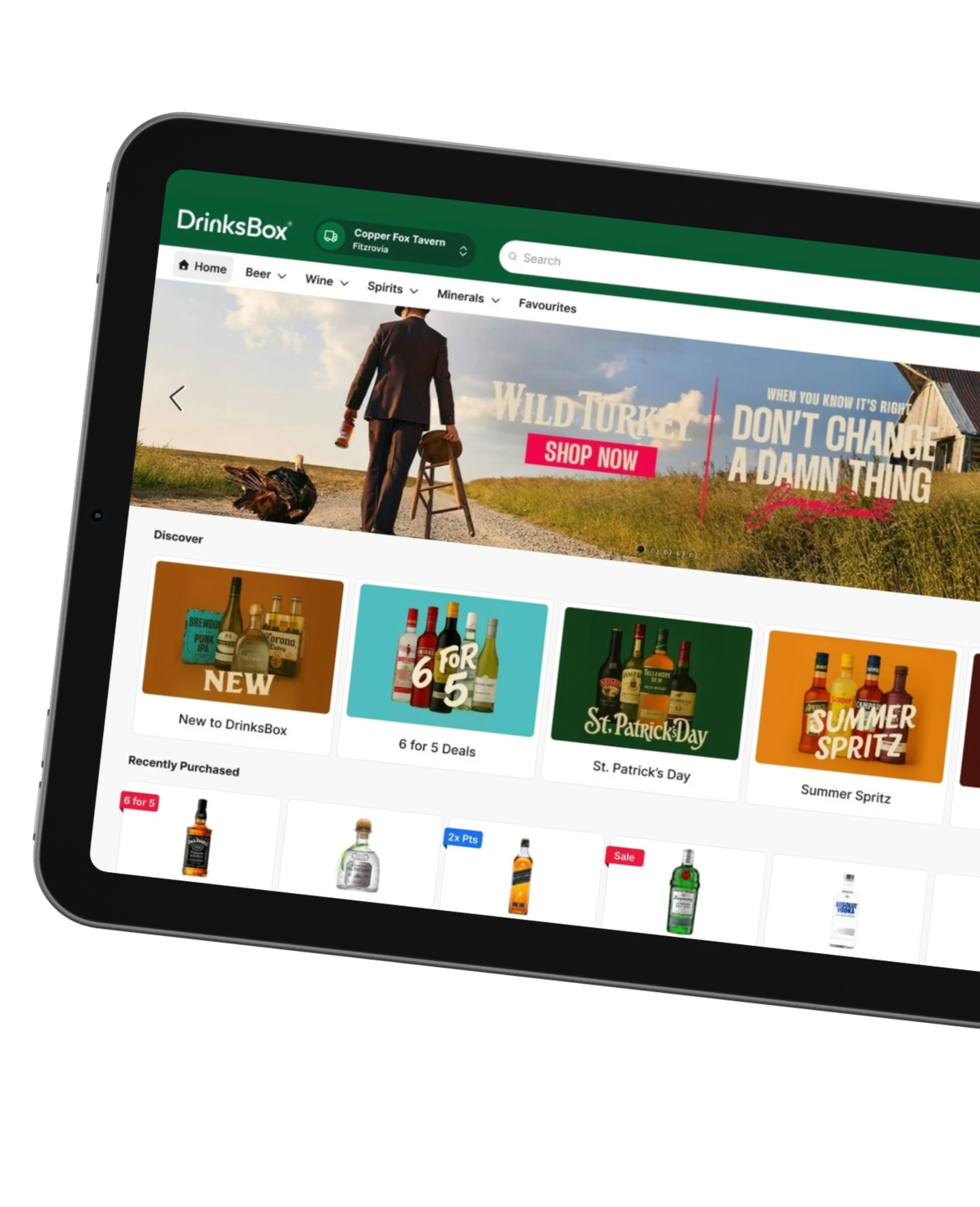 Tablet screen displaying DrinksBox online alcohol store homepage with beer, wine, spirits, and promotional offers.