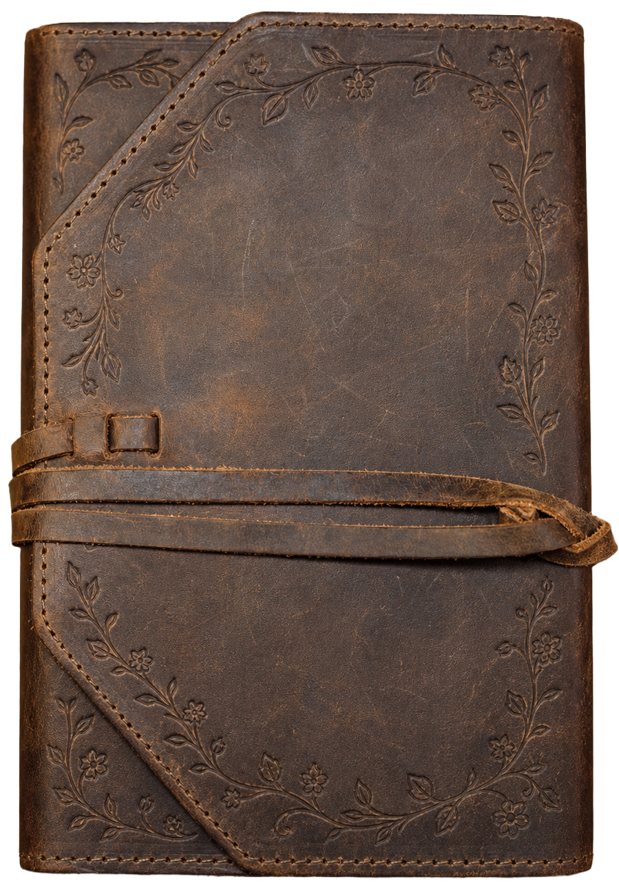 A brown leather journal with floral embossed designs on the cover, featuring a wrap-around strap.