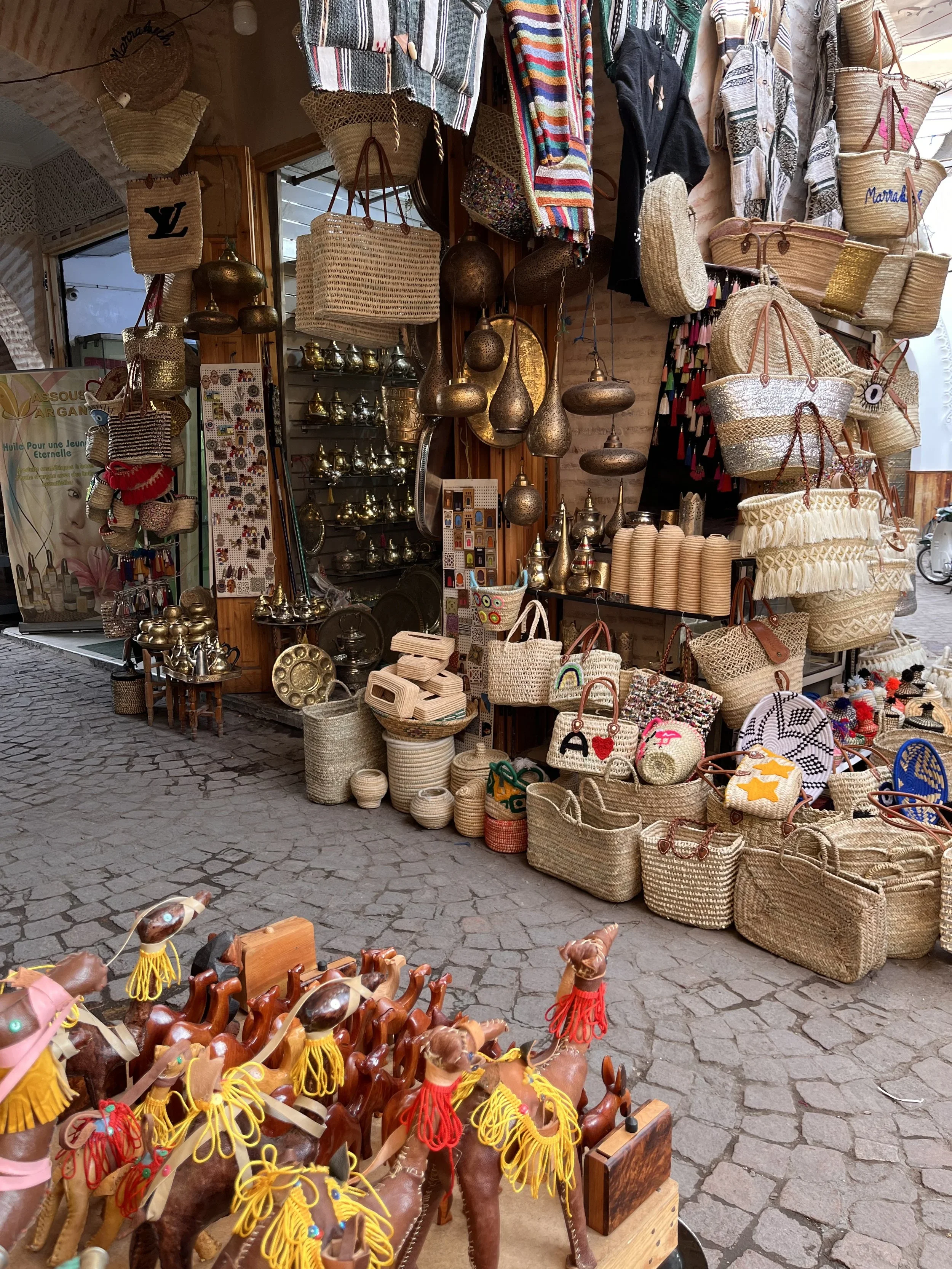 Stall with hand woven baskets and gold lanterns in a Moroccan souk.