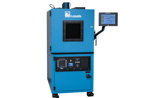 A blue industrial machine with a black window, control panel, and a touchscreen tablet on the side, labeled 'TP Russells'.