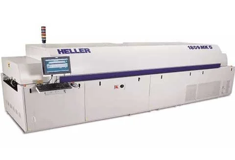 Industrial machine labeled 'HELLER 1800 KGS' with a control panel and computer monitor.