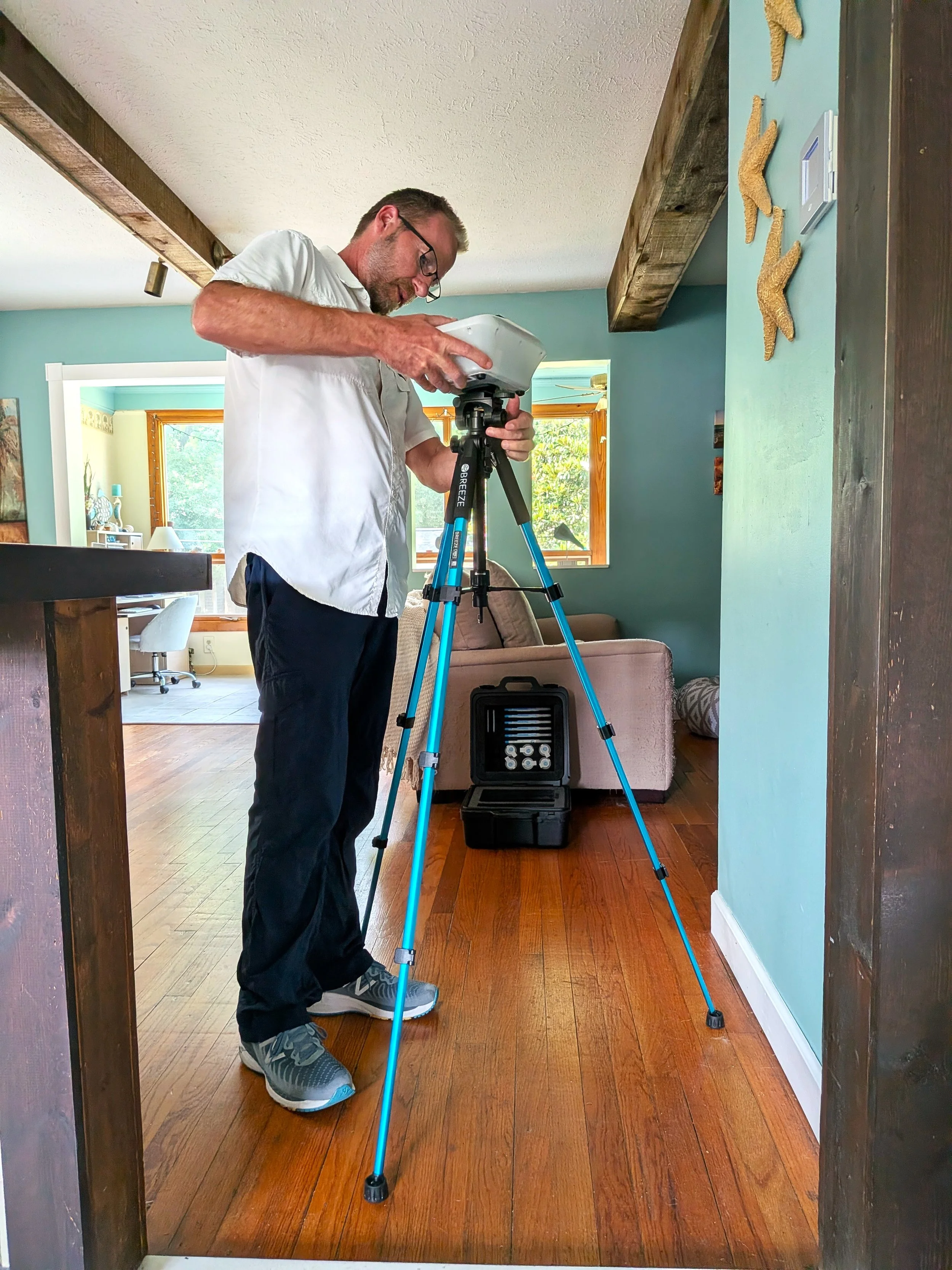 Inspector conducting air quality sampling for mold testing.