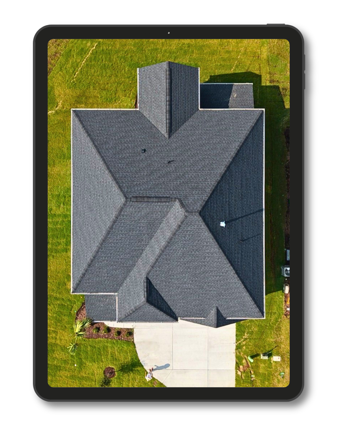 Aerial drone view of residential property and roof.