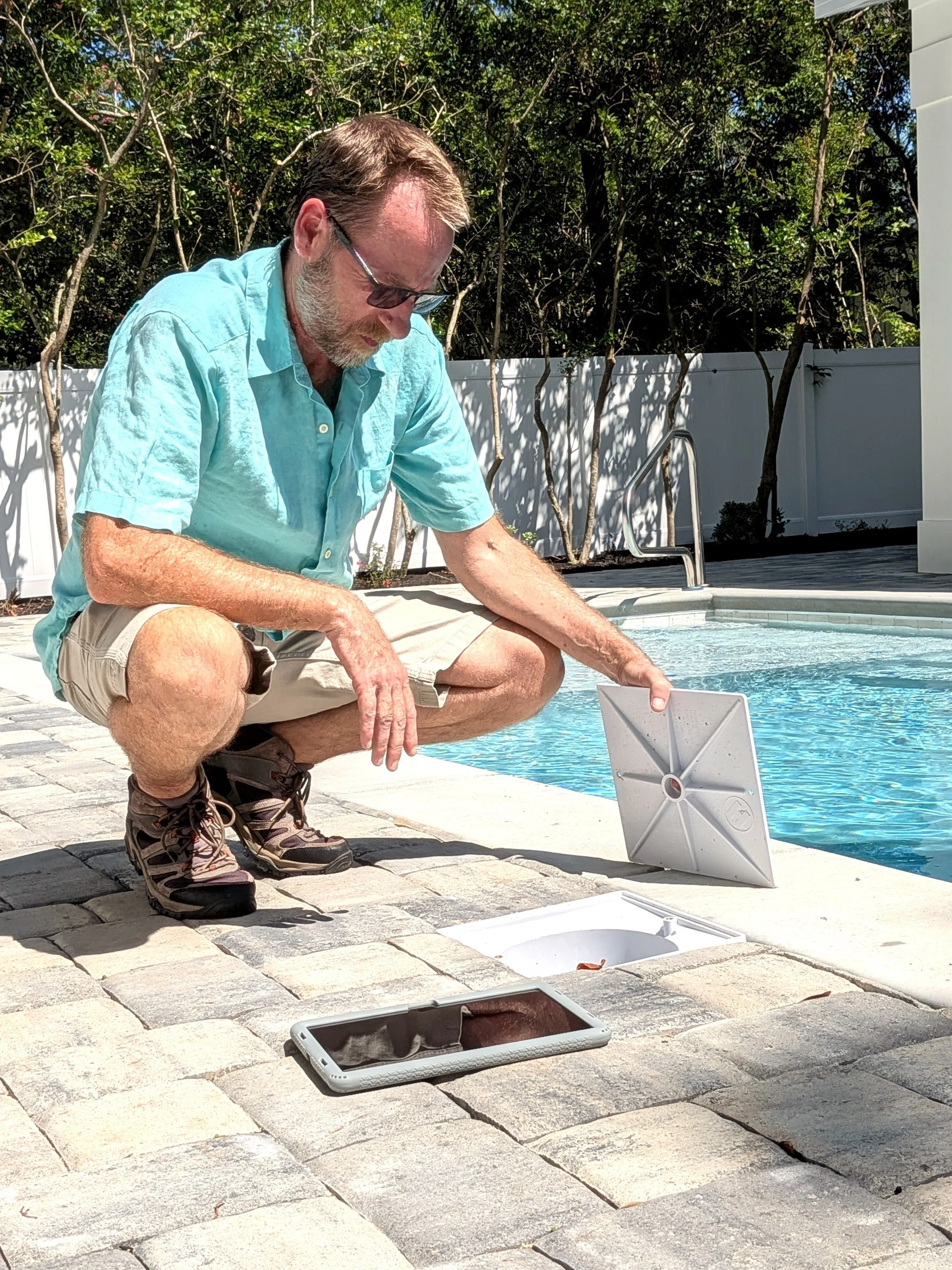 Inspector examining pool skimmer box.