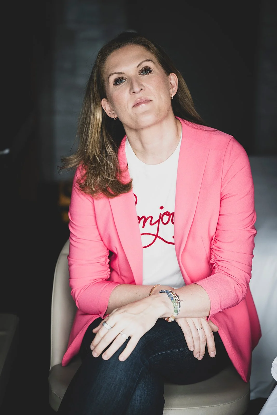 Oksana Lukash seated wearing pink jacket