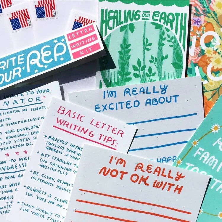 A collection of writing supplies, postcards, and informational sheets with messages about letter writing, environmental themes, and personal feelings.