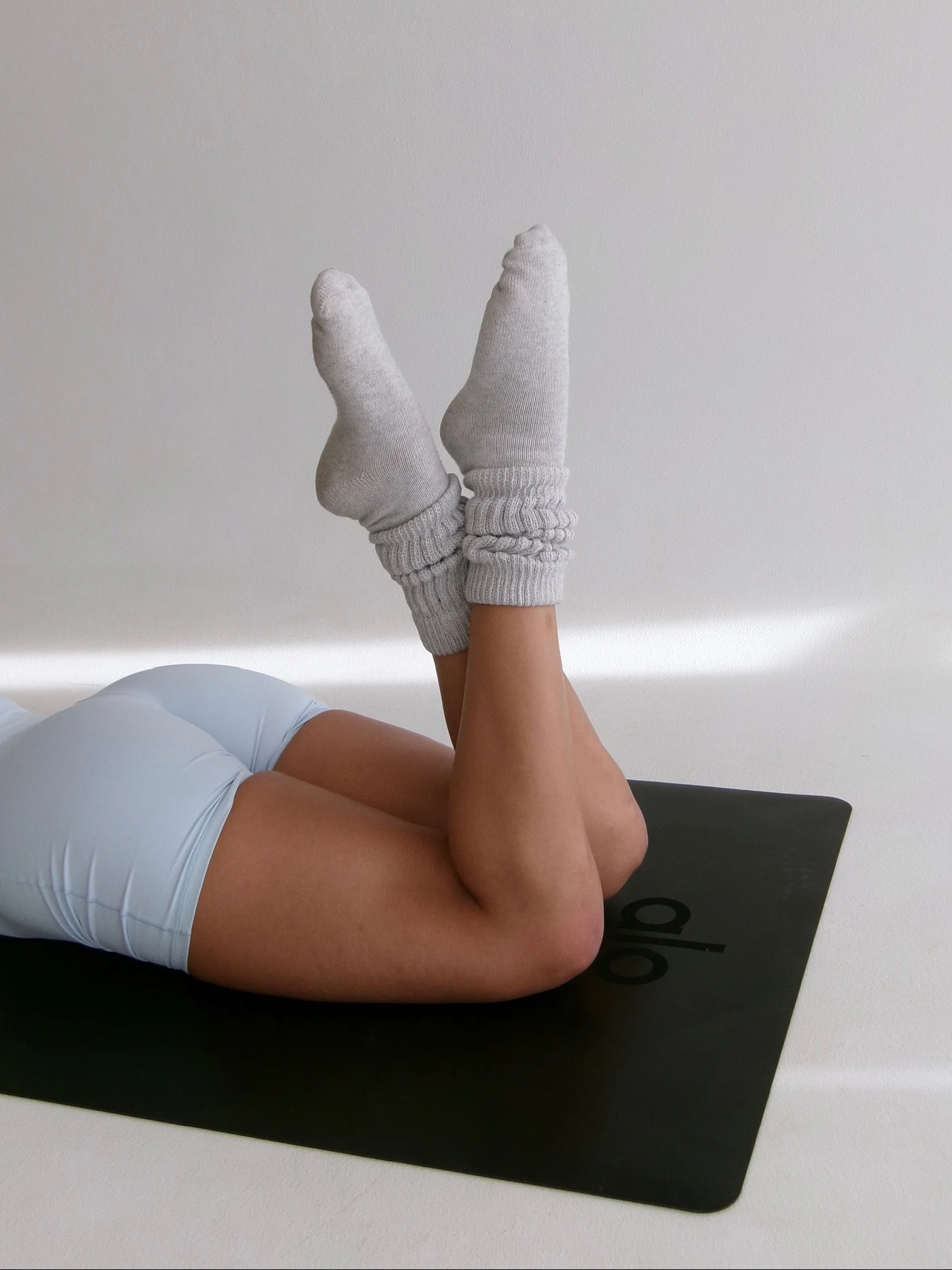 two feet crossed on mat