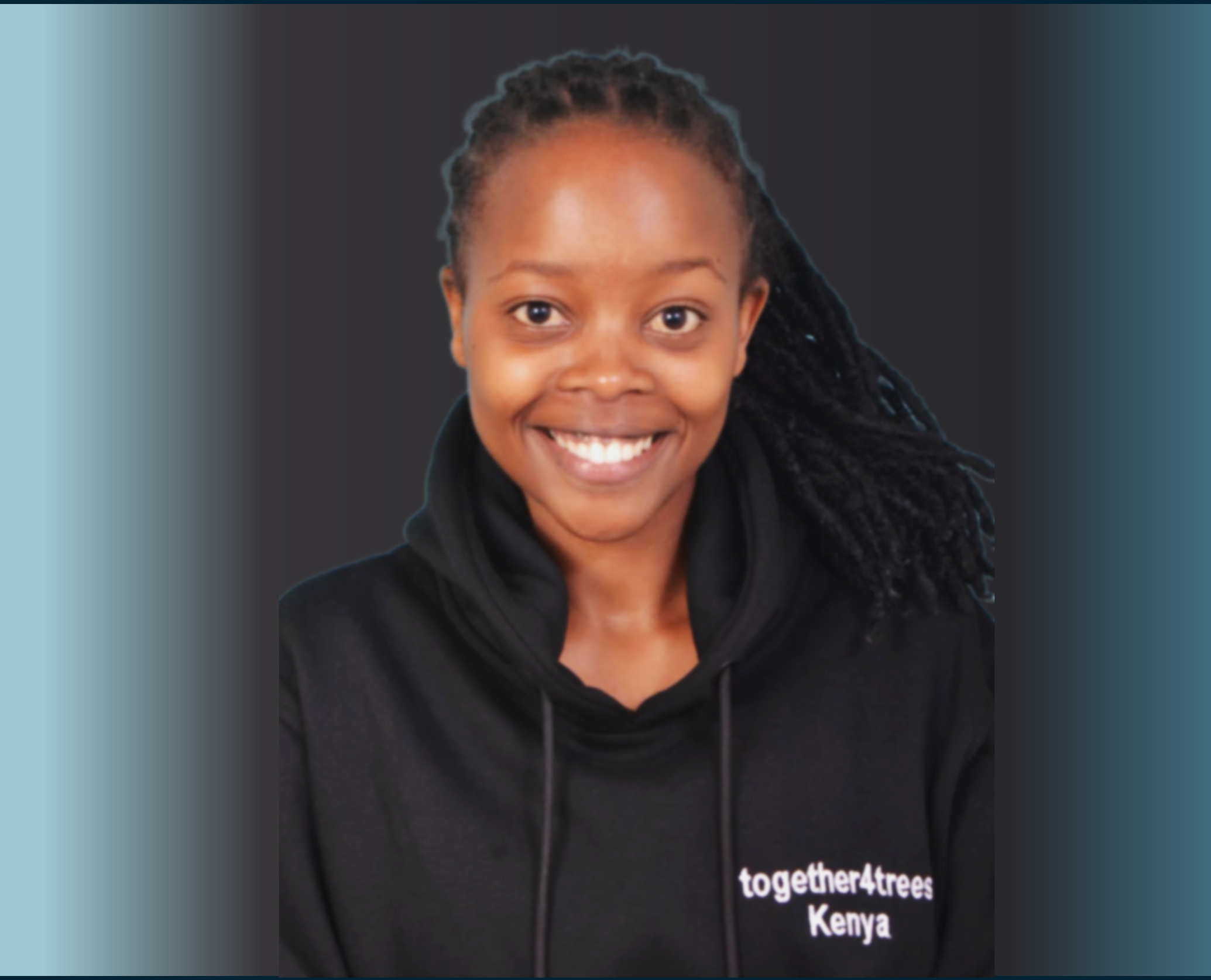 Close-up photo of a smiling woman with dreadlocks, wearing a black hoodie with the words 'together4trees Kenya'.