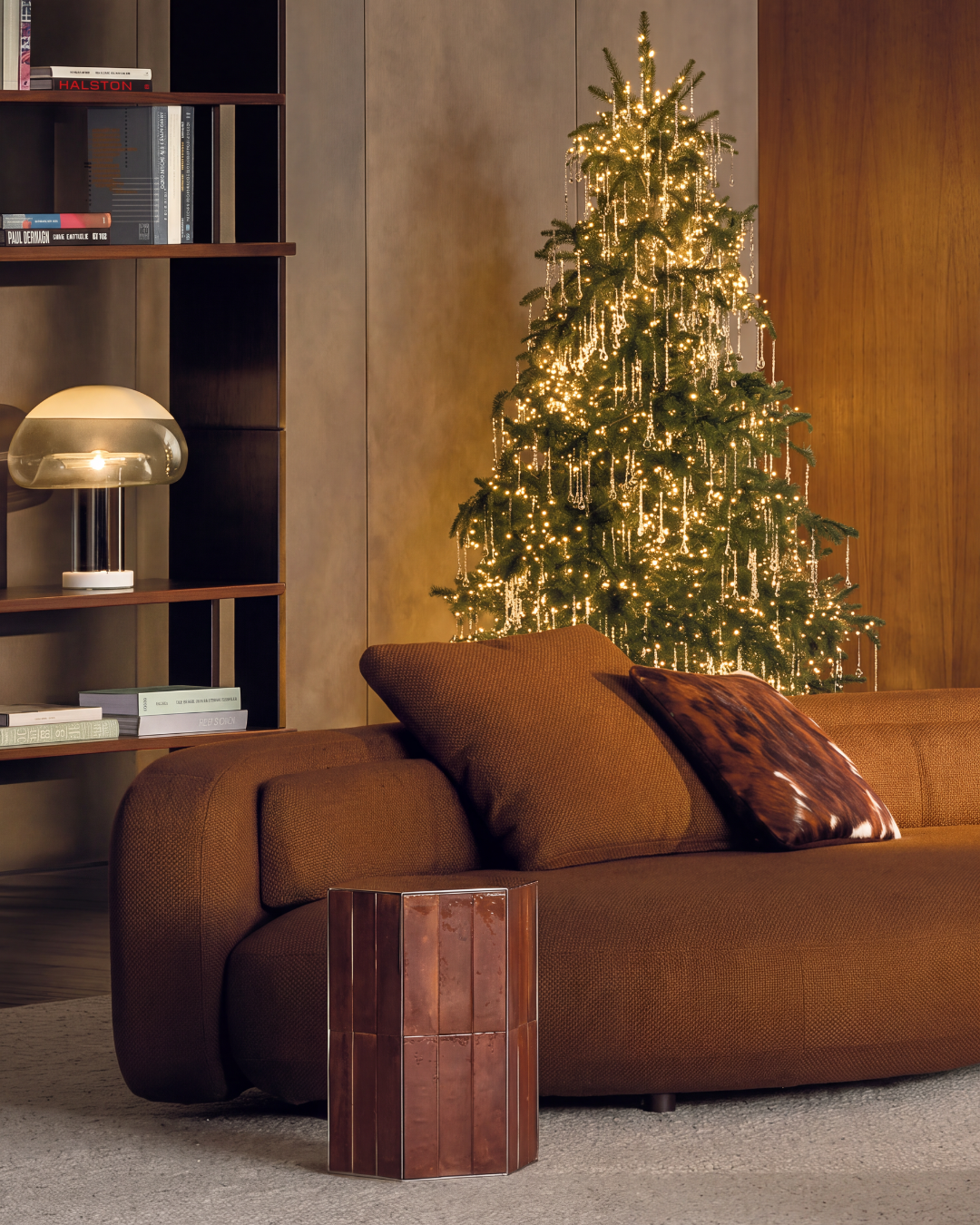 Warm modern living room with a softly lit Christmas tree and cascading crystal strands — luxury holiday design by Jacqueline Row, Atlanta. Concept study.