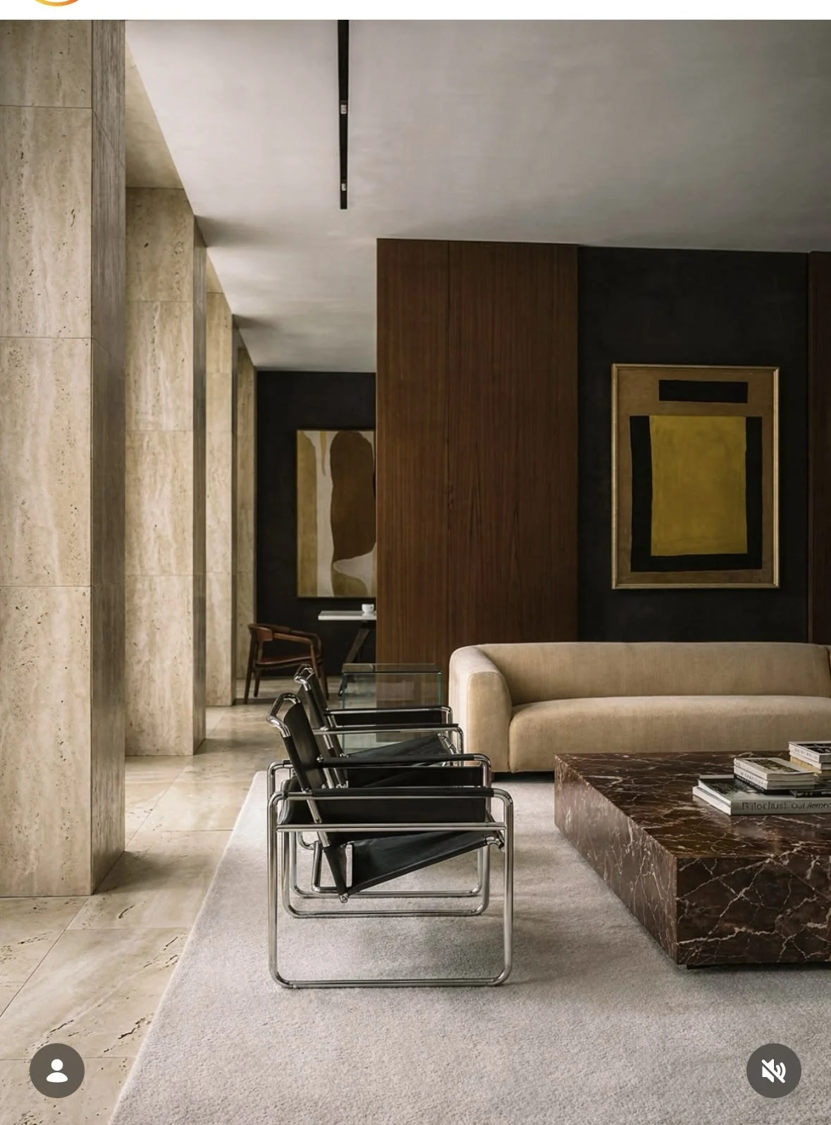 Modern hotel lobby with marble walls, lounge seating, and a stone coffee table — commercial interior design inspiration.