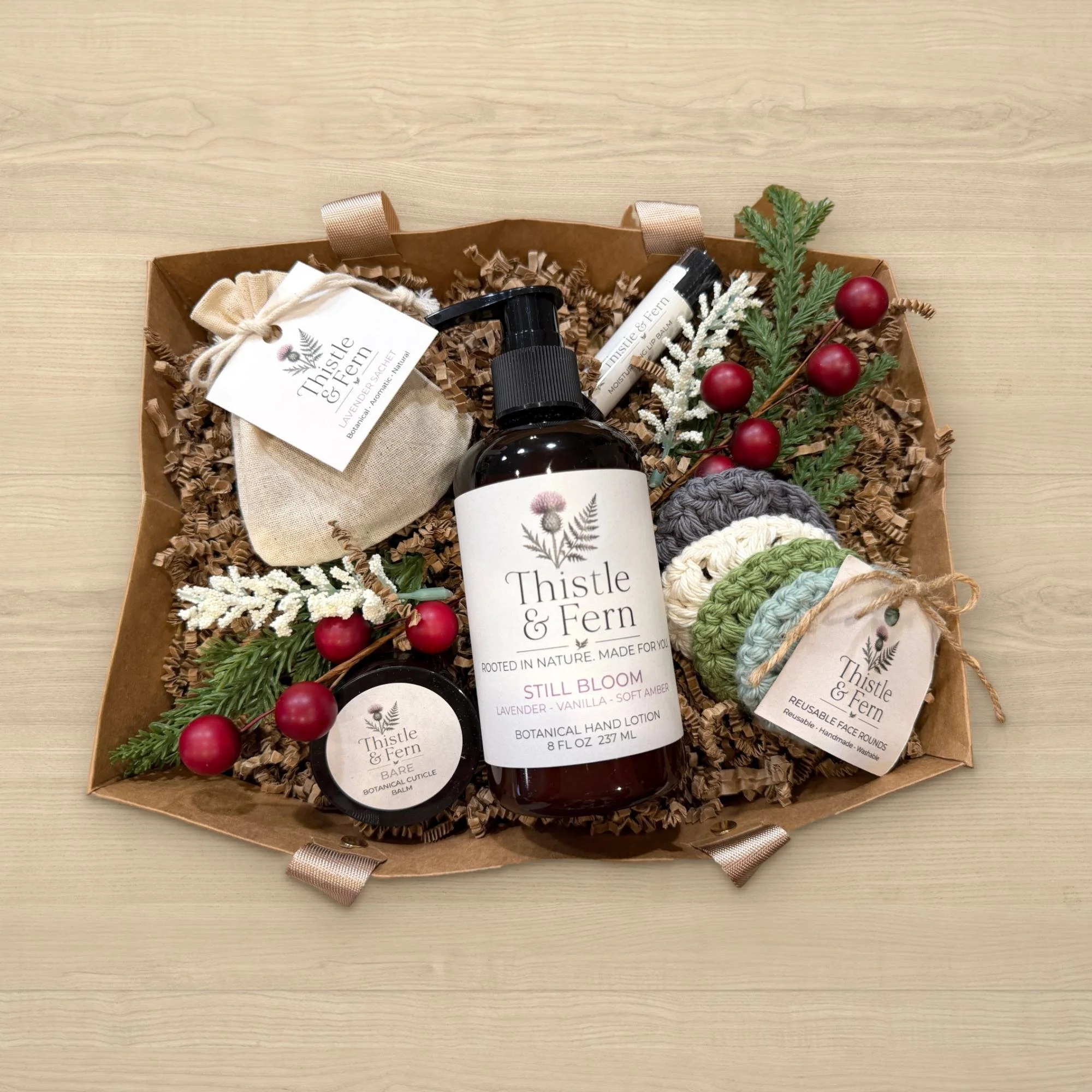 Thistle & Fern Winter Essentials Gift Basket with an 8 oz Botanical Hand Lotion, lip balm, cuticle balm, Lavender Botanical Sachet and Reusable Face Rounds