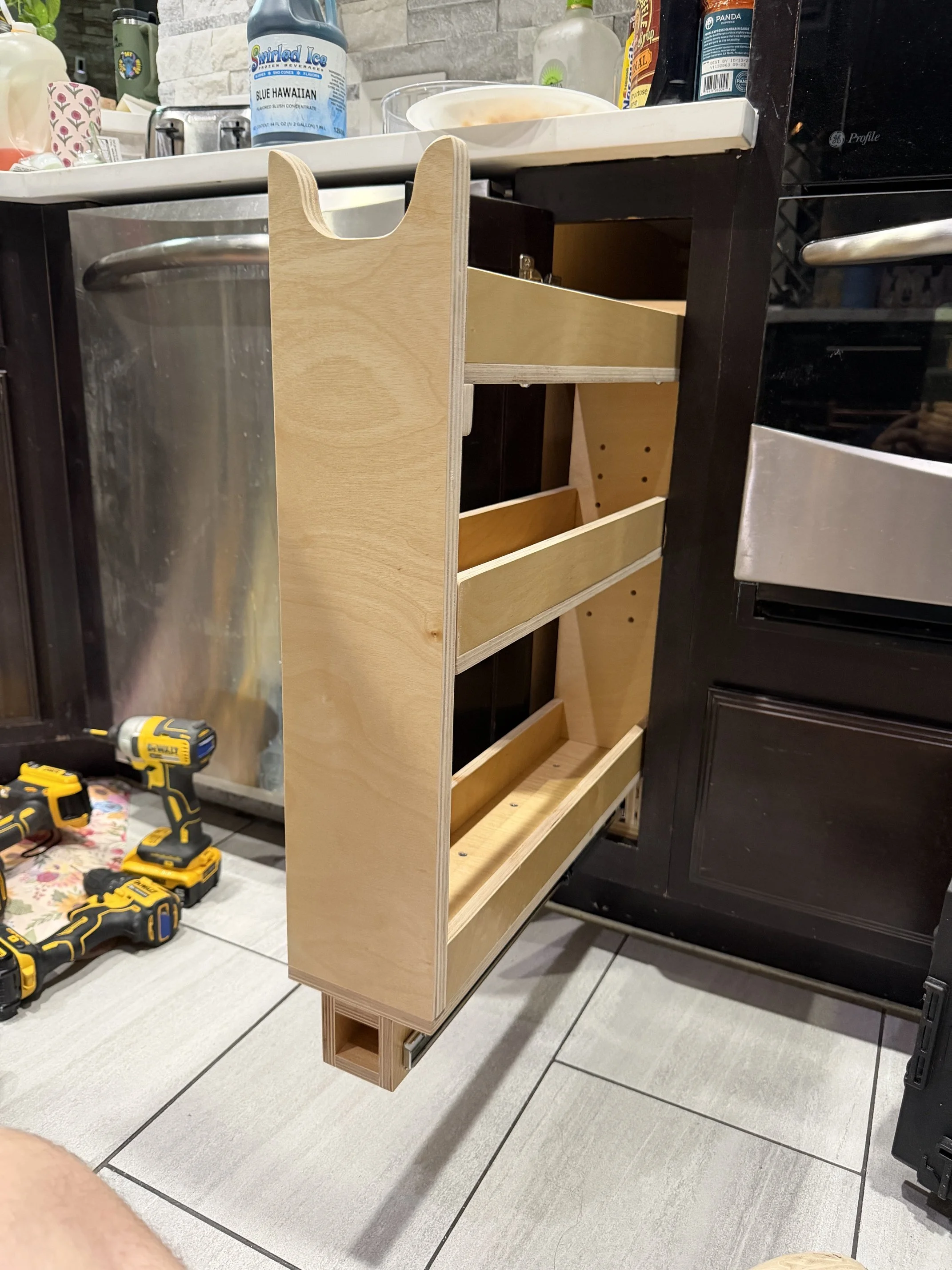 Narrow and tall pull out drawer for small cabinet space. Drawer is fully extended showing three shelf design.