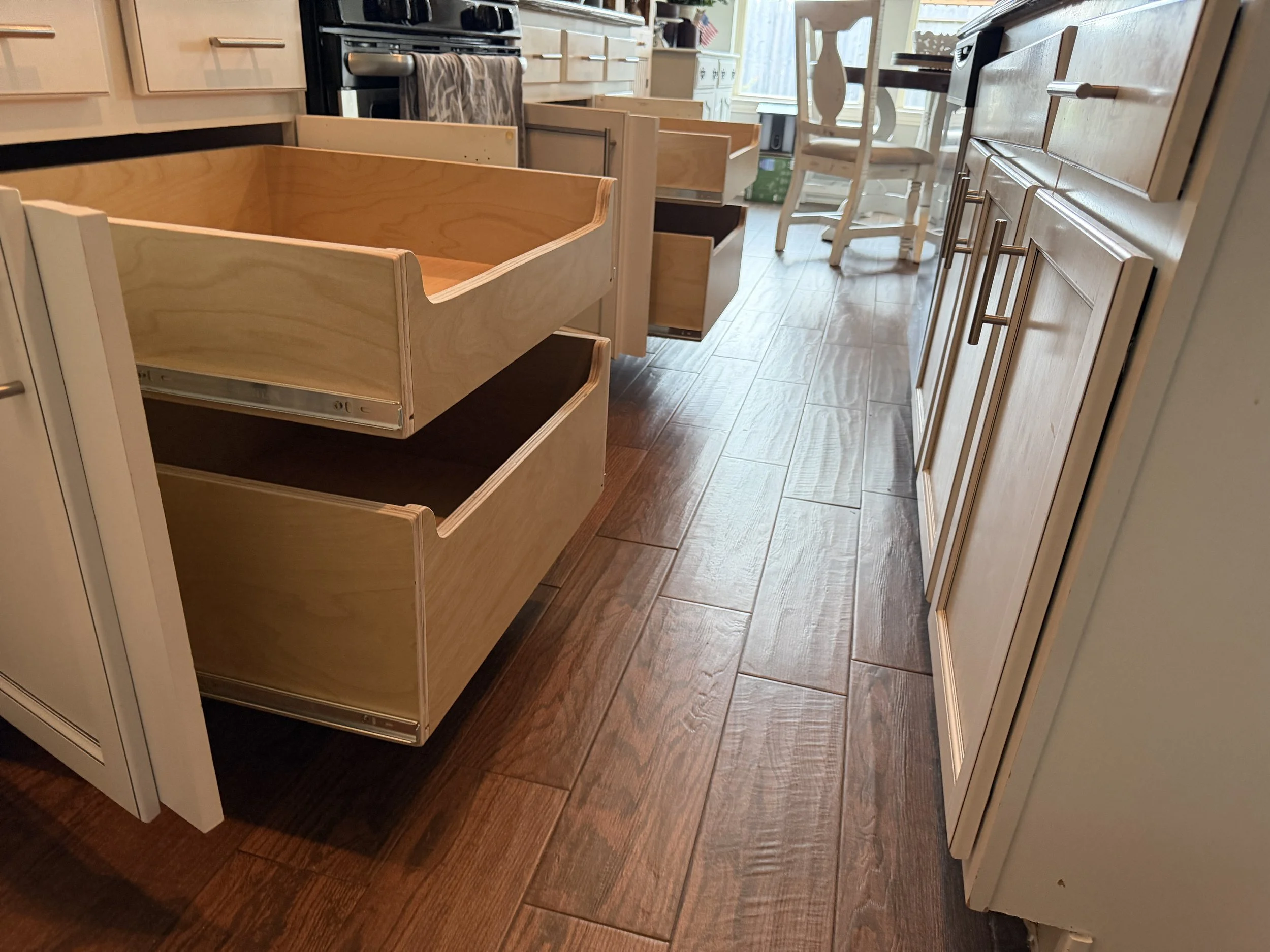 Pull out drawers on either side of stove and over.