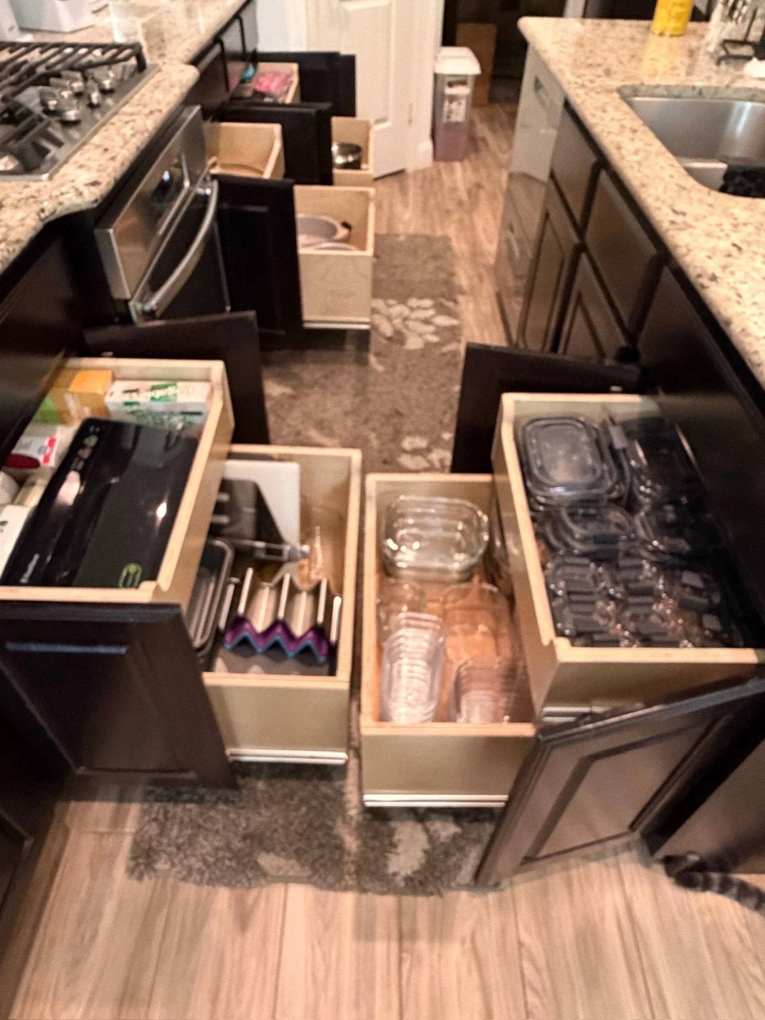 Multiple pull out kitchen drawers in kitchen.