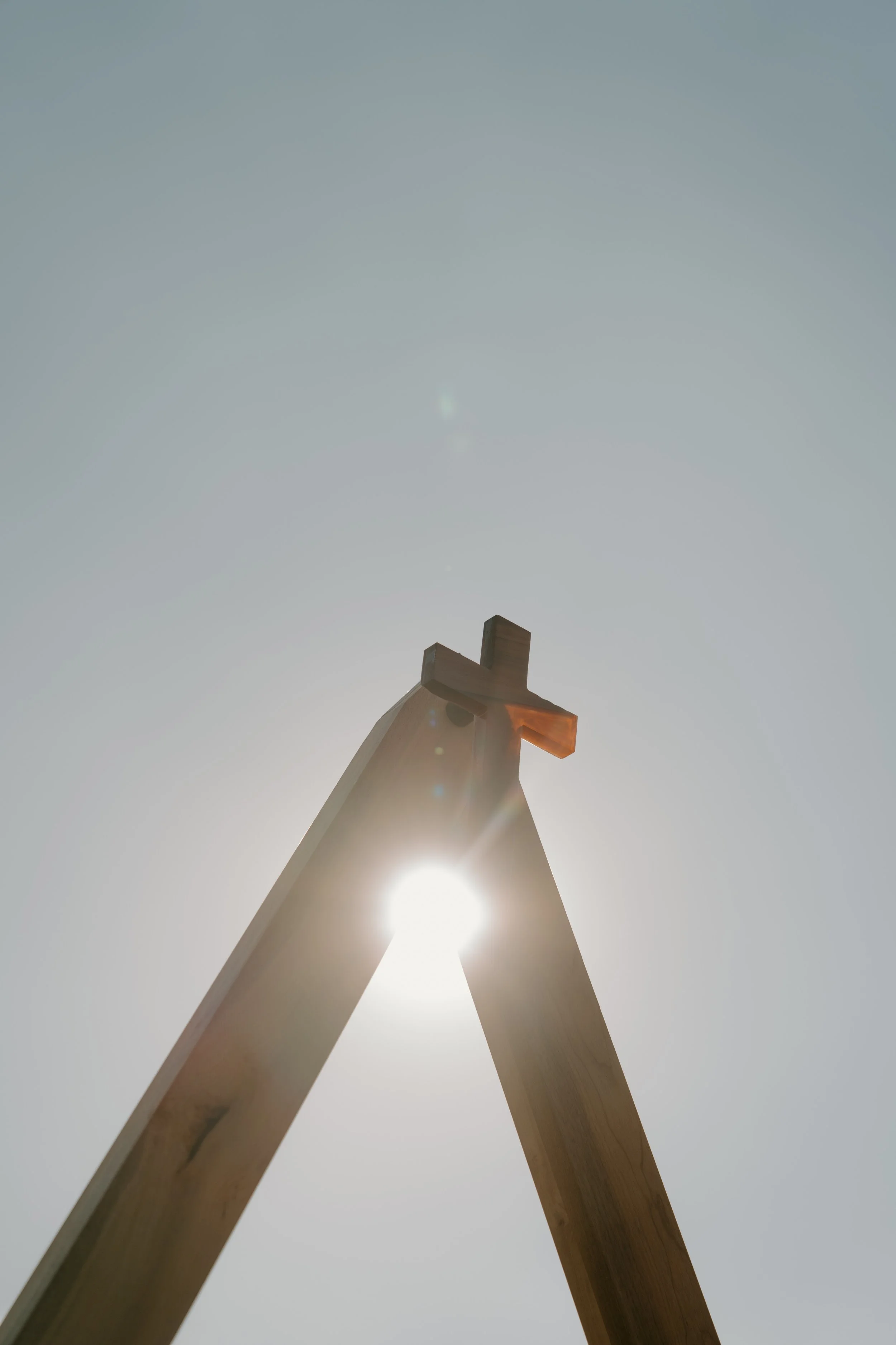 Custom build hardwood triangle and epoxy cross built for a wedding backdrop.