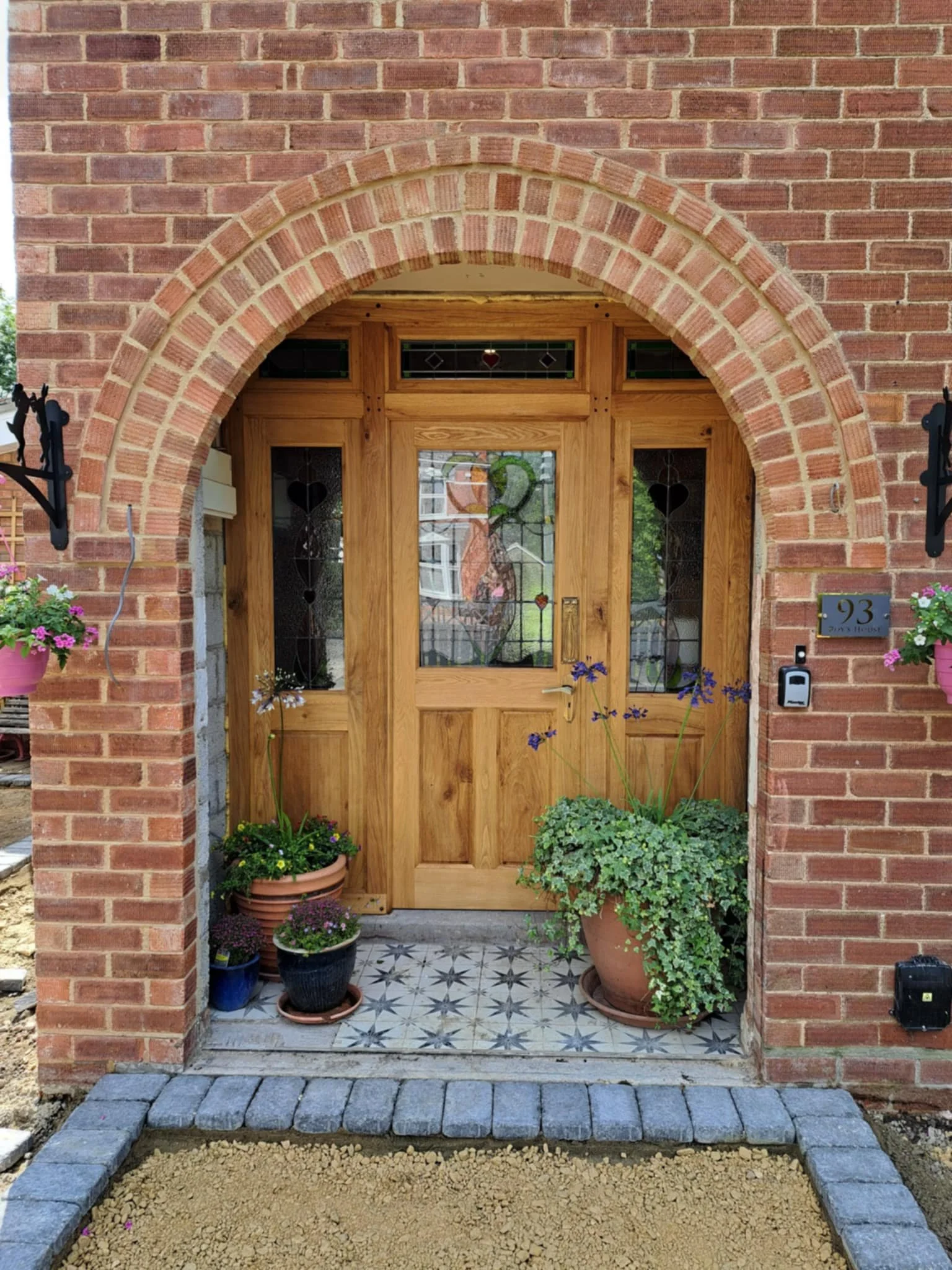 Handcrafted solid oak mortise and tenon frame with black walnut pegs and a stained glass door panel, made to order for a timeless traditional finish.