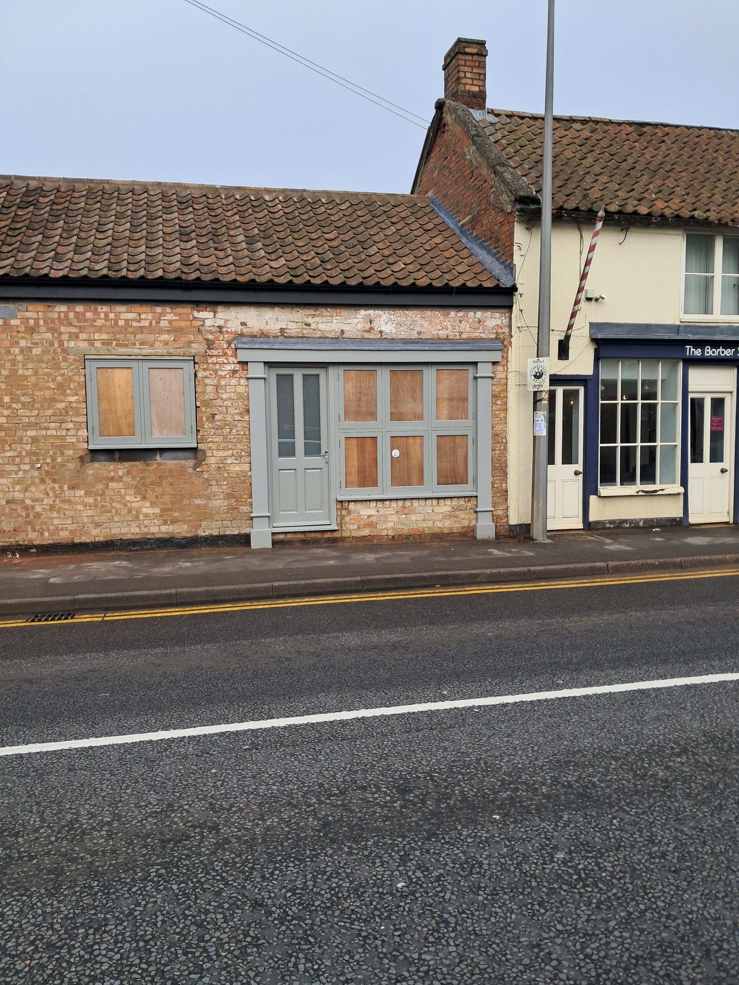 Conservation windows, traditional entrance door and fully bespoke timber shopfront — designed and installed to complement the historic fabric of a Grade II listed building and satisfy Listed Building Consent requirements.