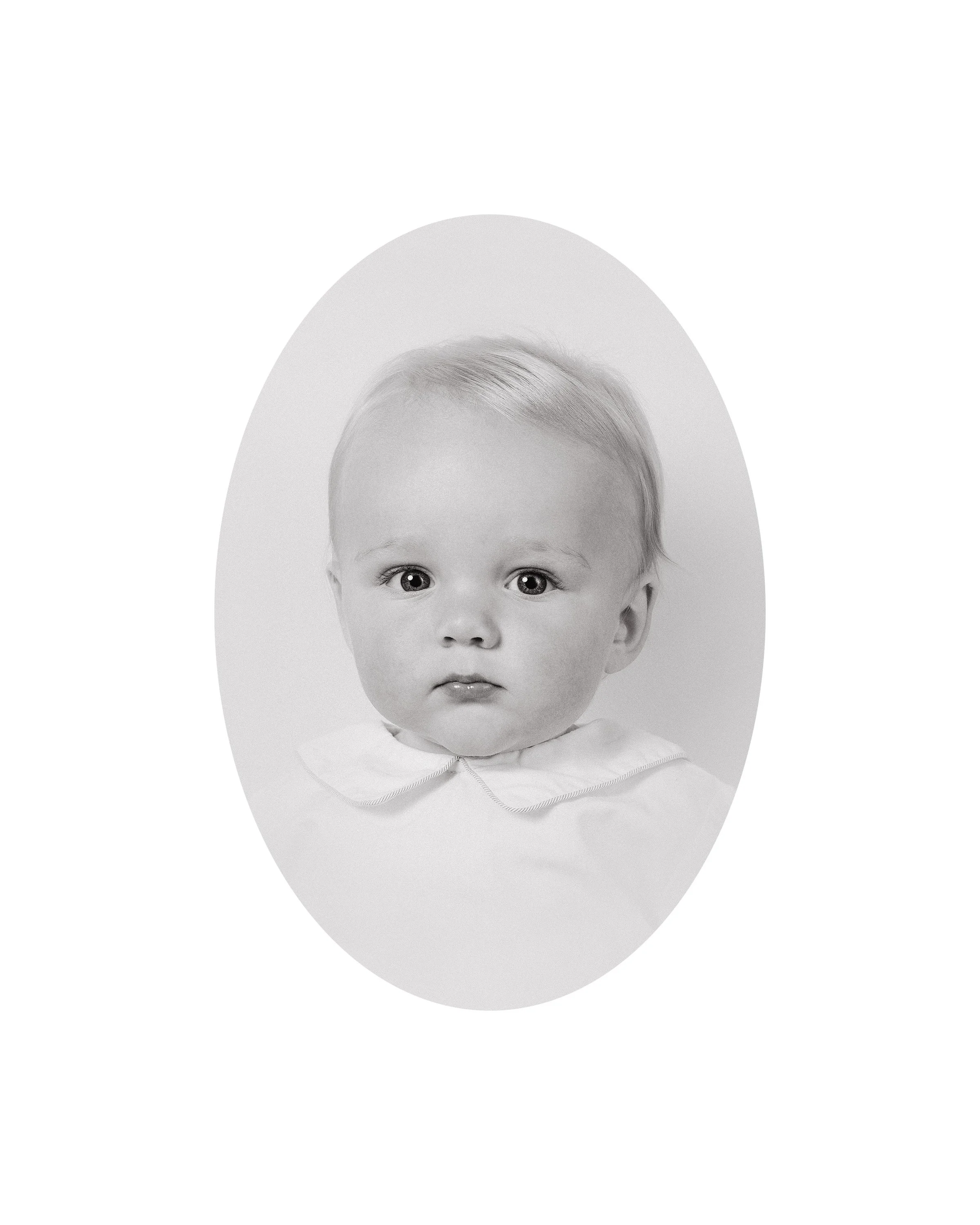 A black-and-white heirloom portrait of a young child with large, expressive eyes and light-colored hair, looking directly at the camera, with the head and shoulders visible. Credit: Philip Winham
