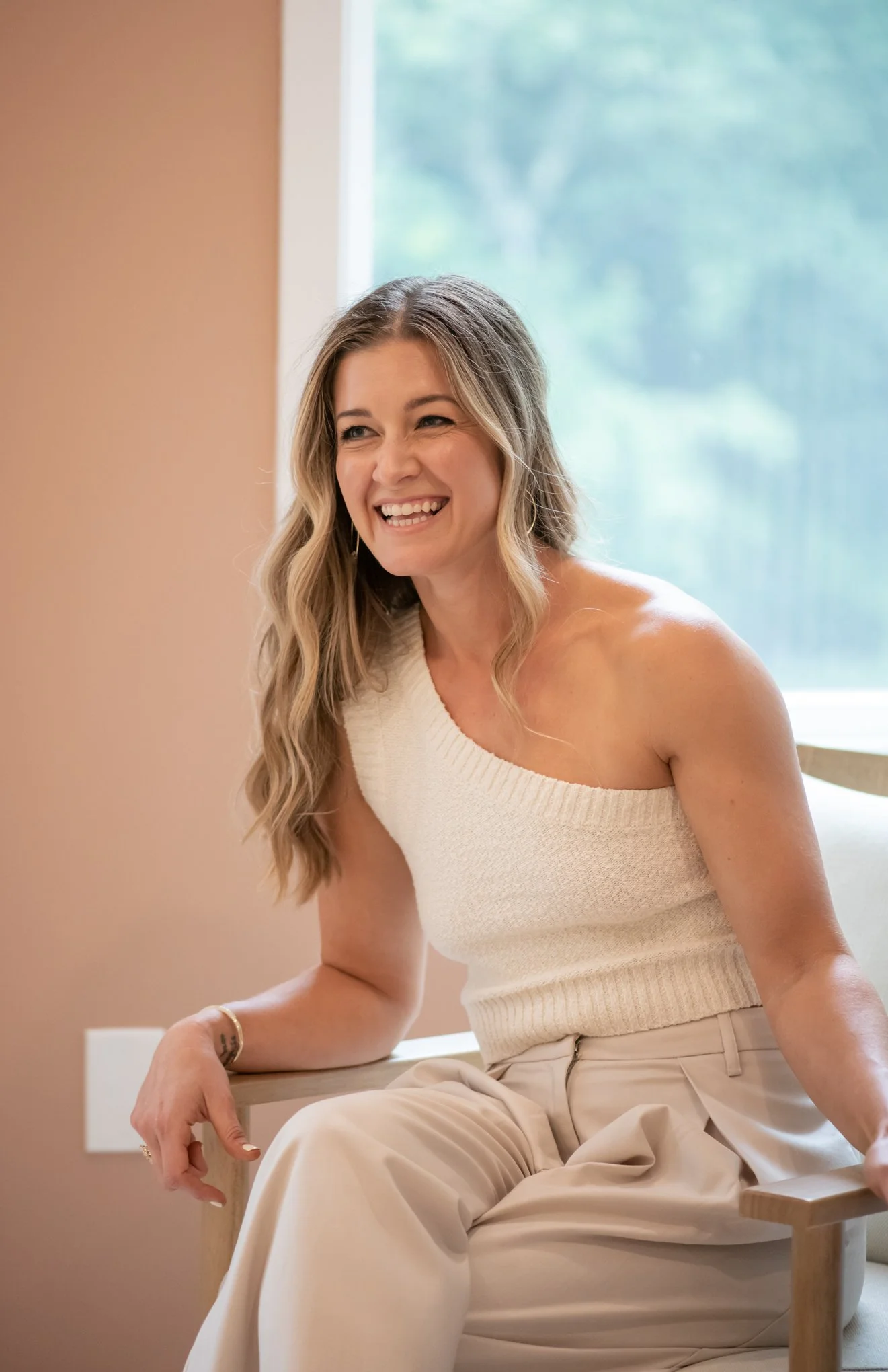 Marissa Mihos nervous system coach sitting in natural light