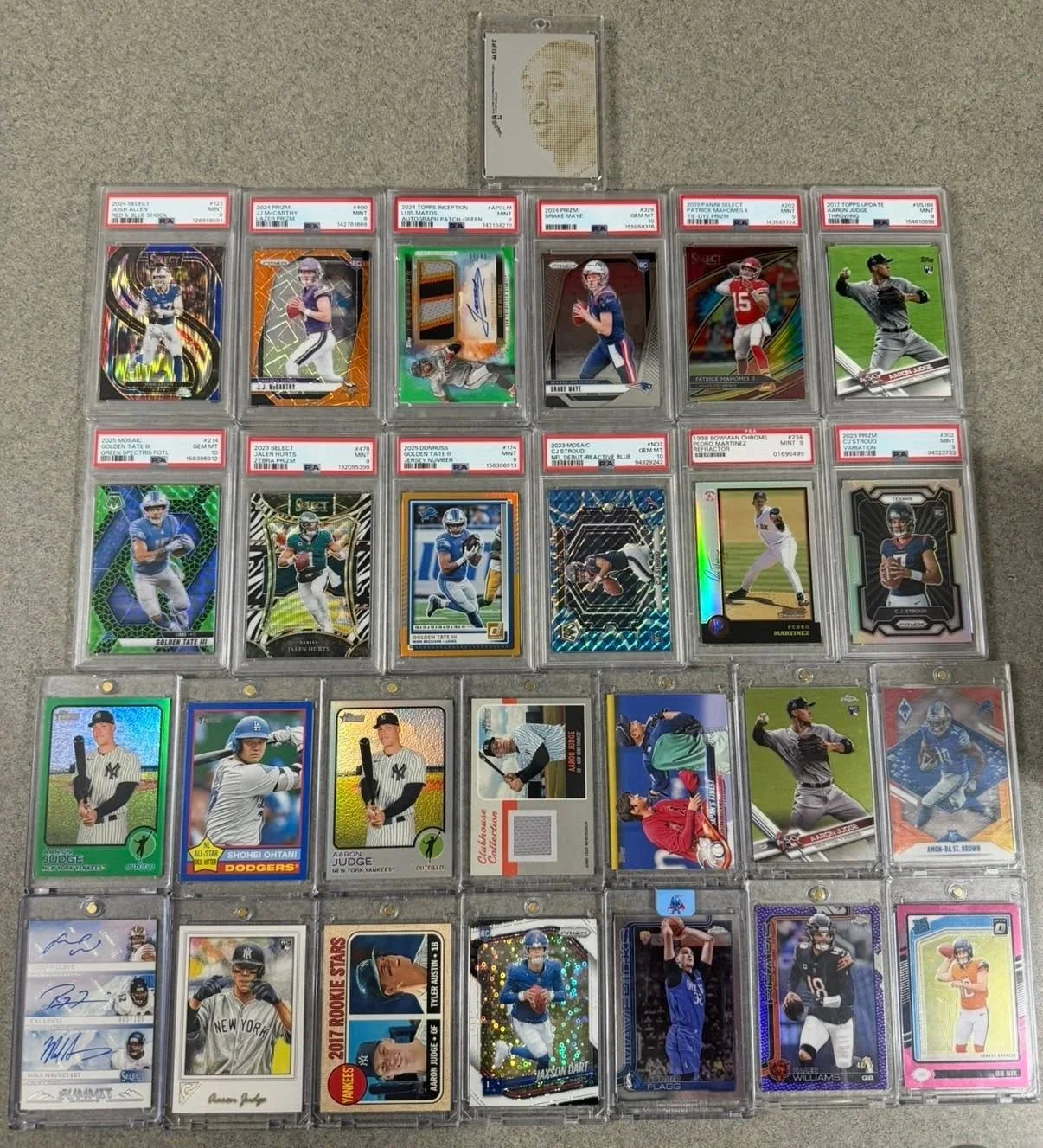 A collection of 30 sports trading cards organized in a 6 by 5 grid on a flat surface, featuring baseball and football players.